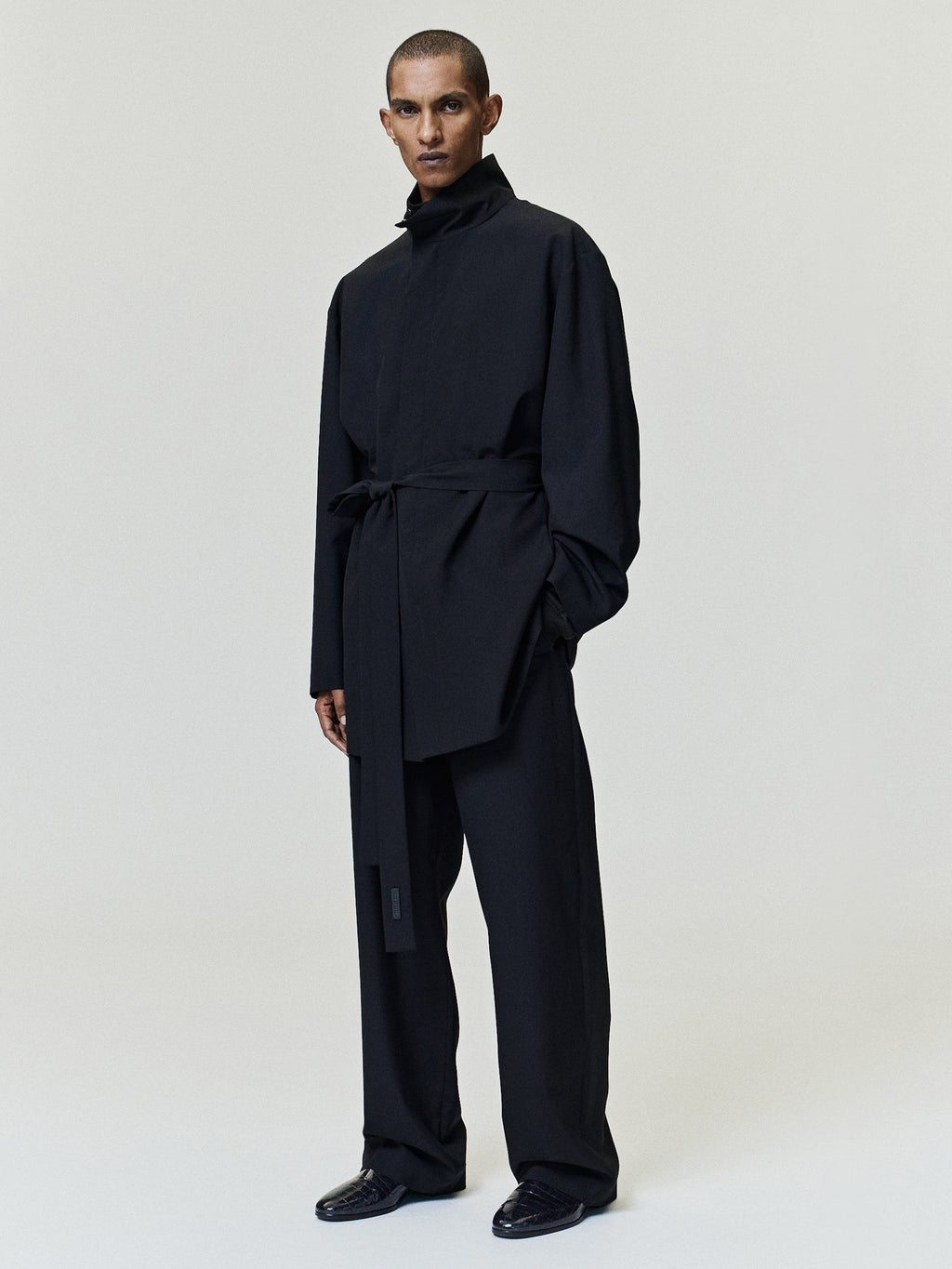 Wool Ripstop Casual Flat Front Pants worn in black with straight legs and a relaxed fit styled in a layered dark outfit as Bottoms