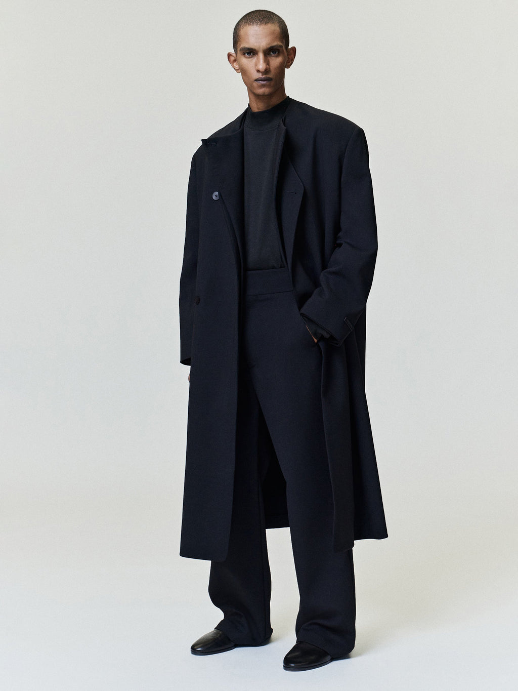 Double Weave Wool Flared Flat Front Pants worn in dark navy with a high waist clean front and flared legs as Bottoms