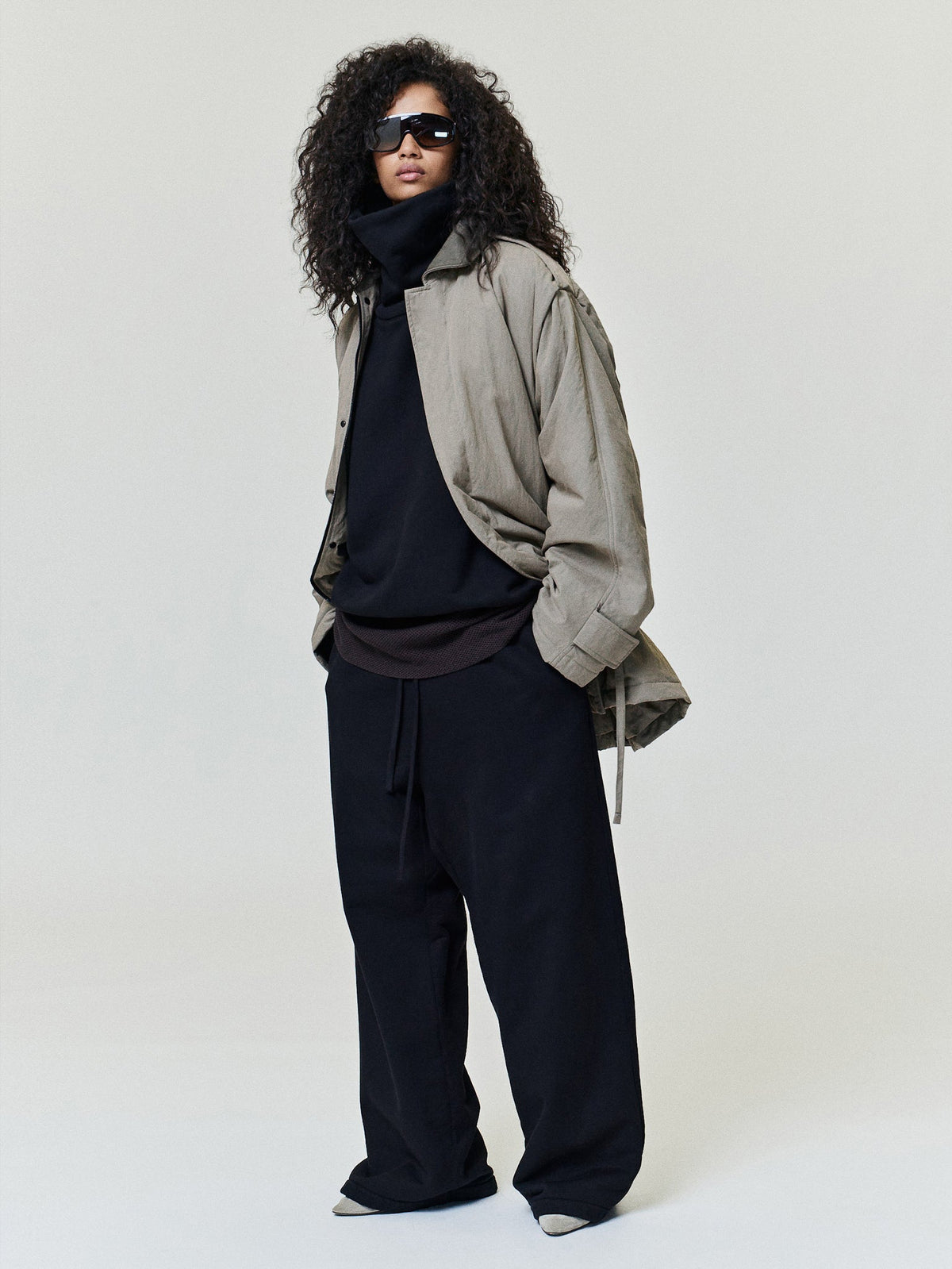 Wide Leg Sweatpants modeled in black with a relaxed wide leg fit elastic drawstring waist and straight hems styled with layered outerwear as Bottoms