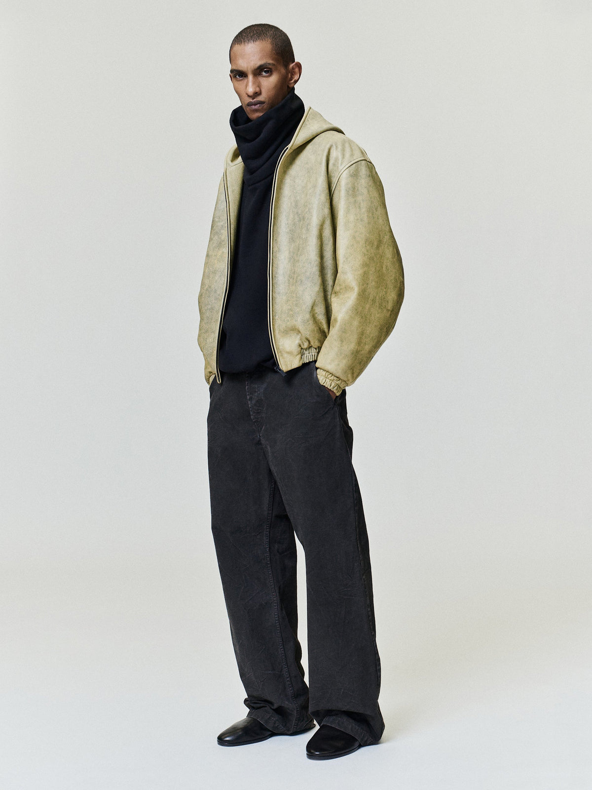 Canvas Utility Pant modeled in dark charcoal with a relaxed straight leg fit, roomy silhouette, and utility pocket details as Bottoms