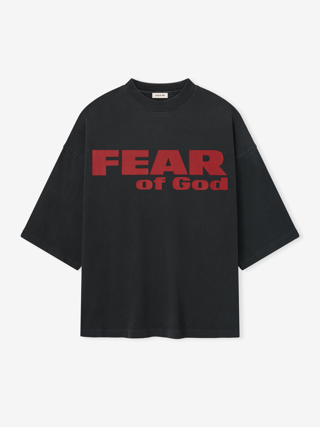 Relaxed Fear Is Gone Tee in black featuring bold red Fear of God lettering across the chest, designed with a loose fit and dropped shoulders for a modern tops style.
