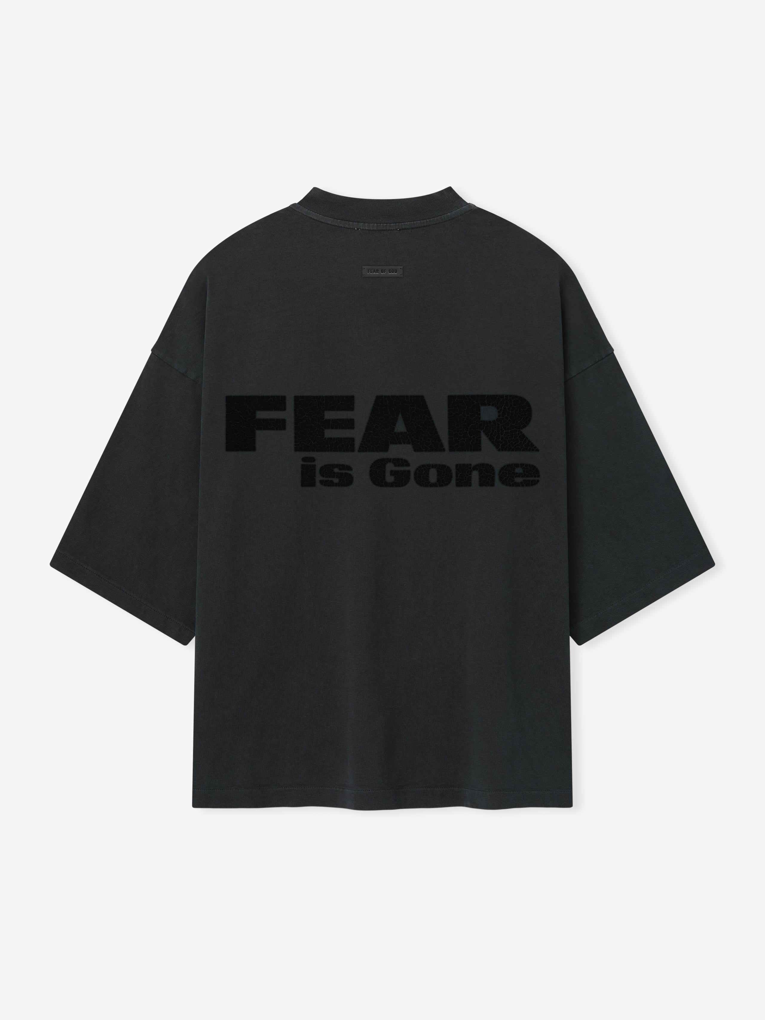 Relaxed Fear Is Gone Tee in faded black featuring large tonal Fear is Gone text across the back, designed with wide sleeves and a loose, oversized fit for casual tops style.