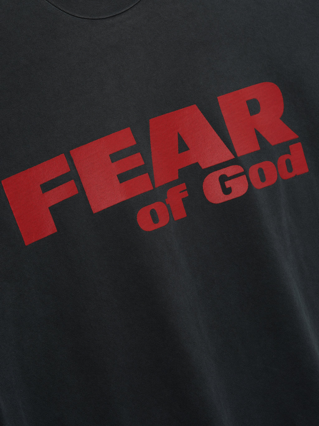 Relaxed Fear Is Gone Tee in black showcasing large bold red Fear of God text across the chest, crafted from soft cotton for a comfortable and stylish casual tops look.