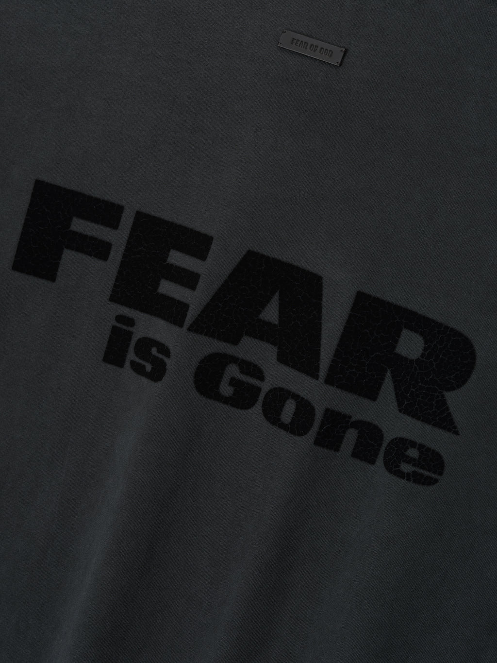 Relaxed Fear Is Gone Tee in black featuring a bold, textured Fear is Gone graphic across the chest with a subtle Fear of God patch above, crafted from soft cotton for casual tops.