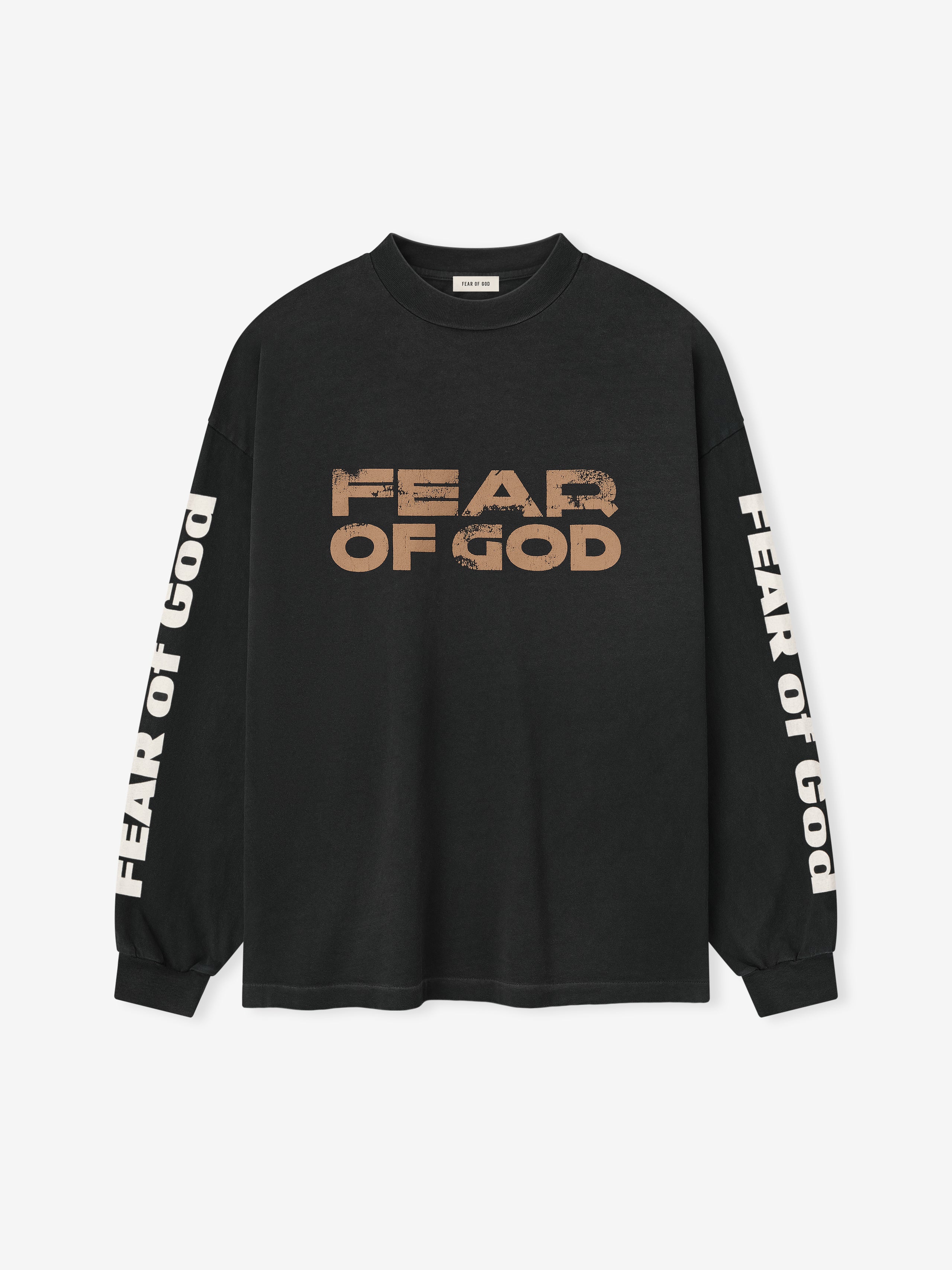 Relaxed Fear Of God Long Sleeve Tee in black featuring distressed beige “FEAR OF GOD” text across the chest and white branding along the sleeves, crafted from soft cotton for a casual tops option.