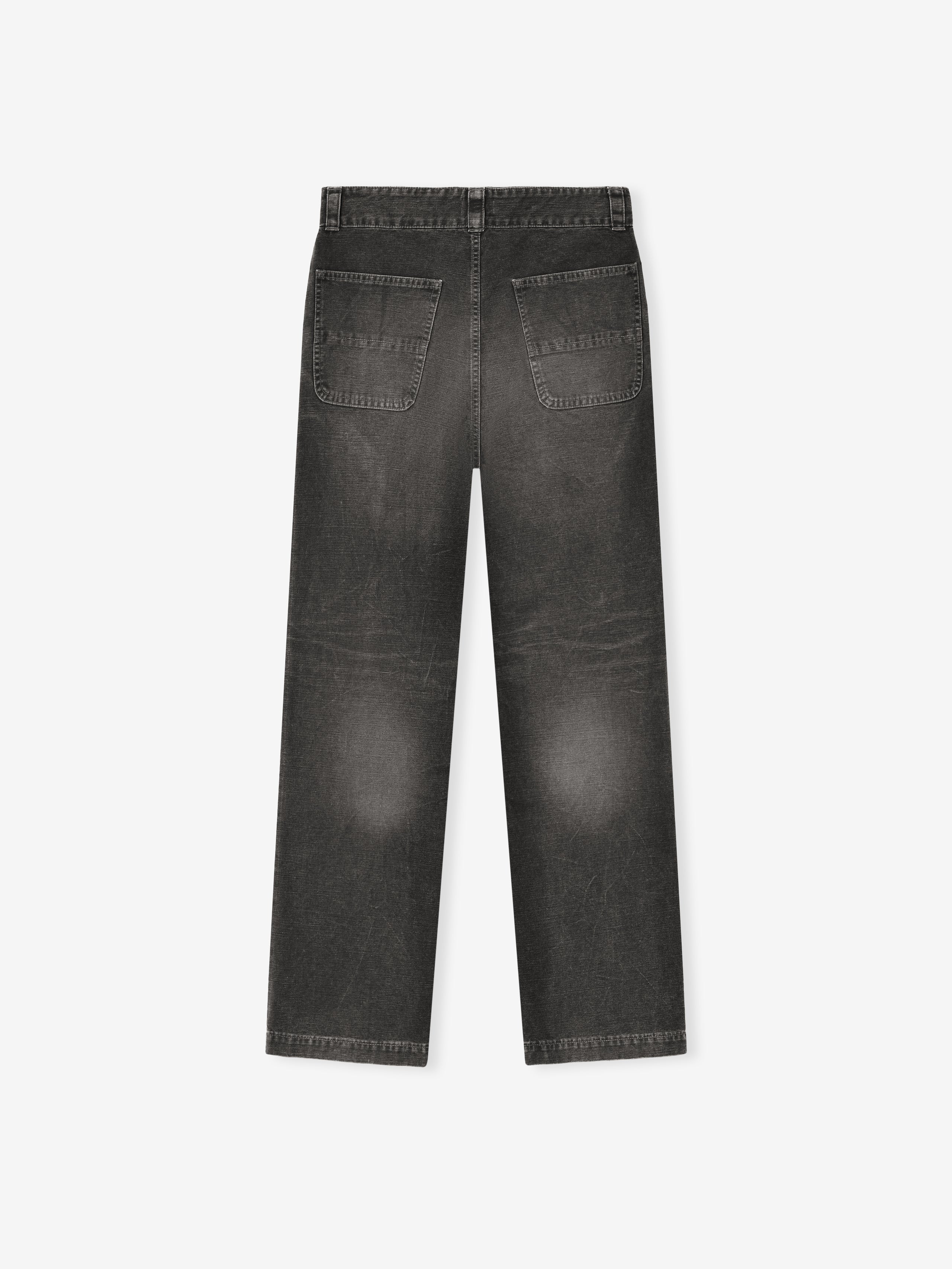 back view of black washed cotton canvas utility pants with relaxed straight leg and patch back pockets