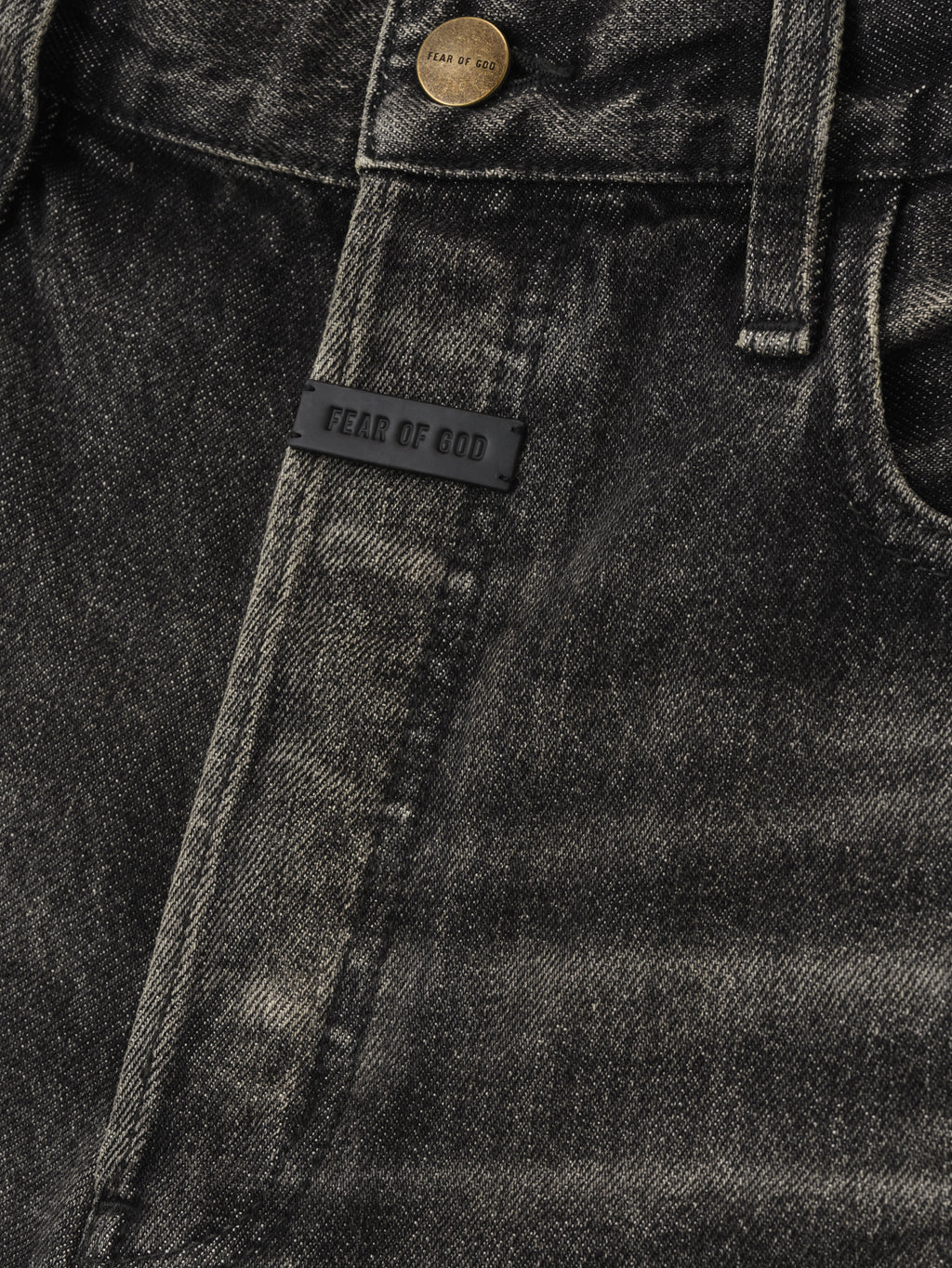 Straight 5 Pocket Jean in a worn black wash featuring tonal stitching, branded metal button, and a small black Fear of God label for subtle designer detailing on denim bottoms.