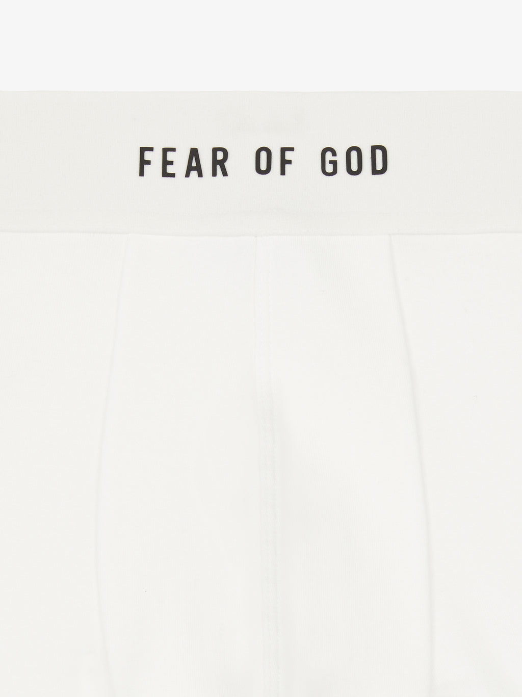 close-up of white rib-knit brief with plush elastic waistband branded Fear of God in black text