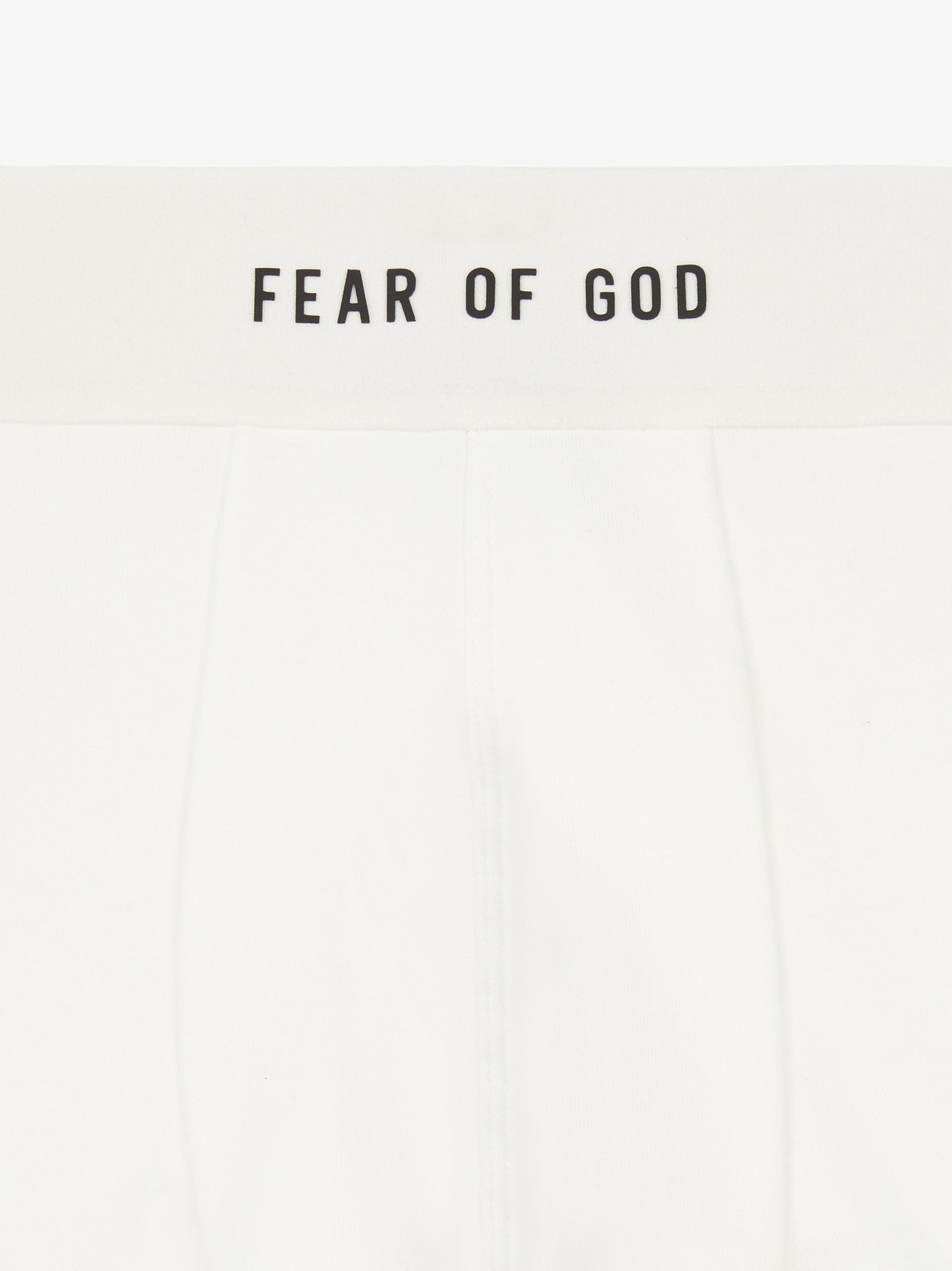 close-up of white rib-knit brief with plush elastic waistband branded Fear of God in black text