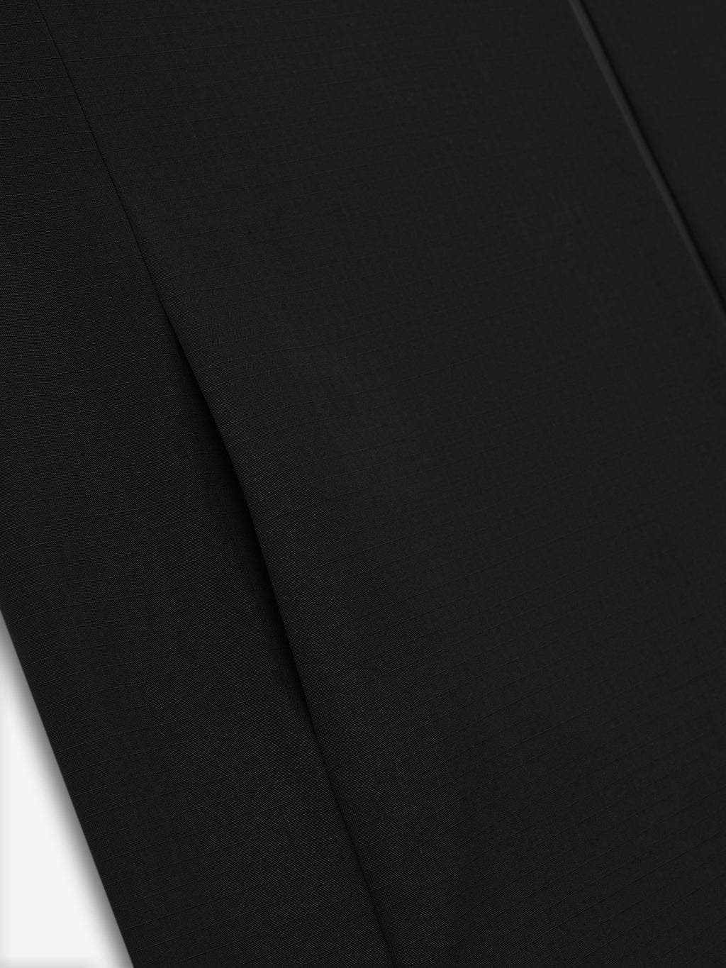 close-up of black lightweight wool ripstop fabric with subtle grid texture and smooth finish