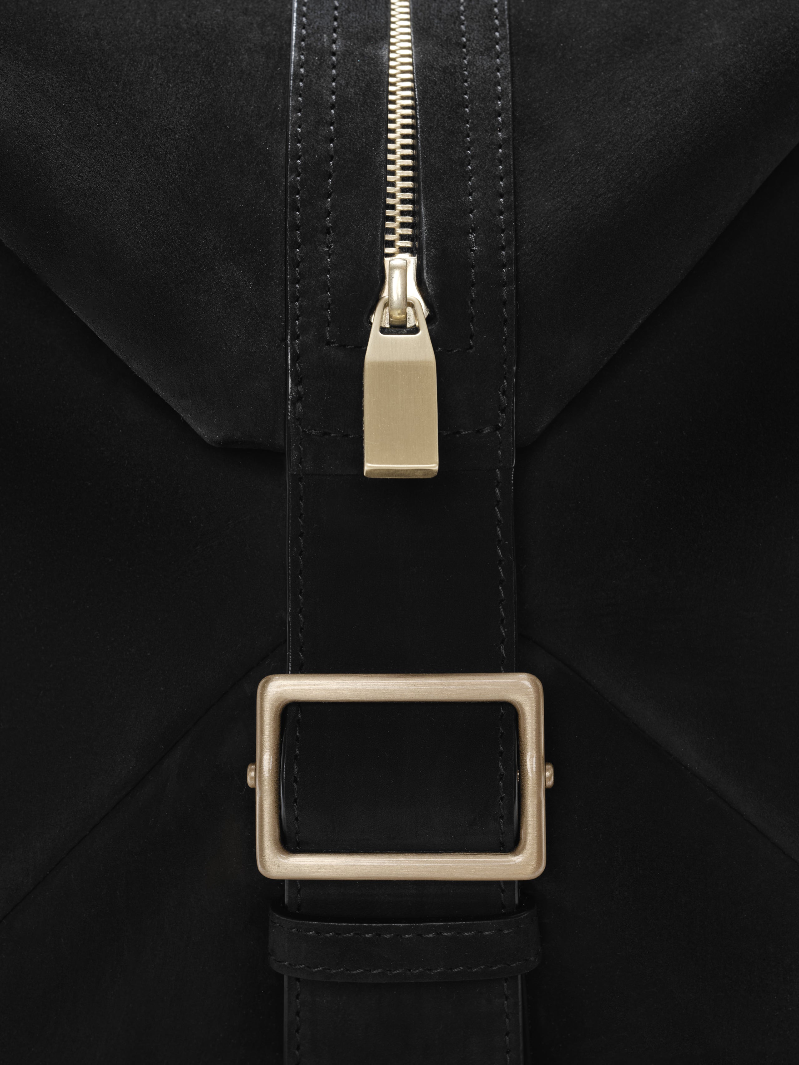 Close-up of a black Large Belted Duffle featuring a matte leather strap with neat stitching, a rectangular brushed metal buckle, and a polished gold-tone zipper pull for refined detailing.