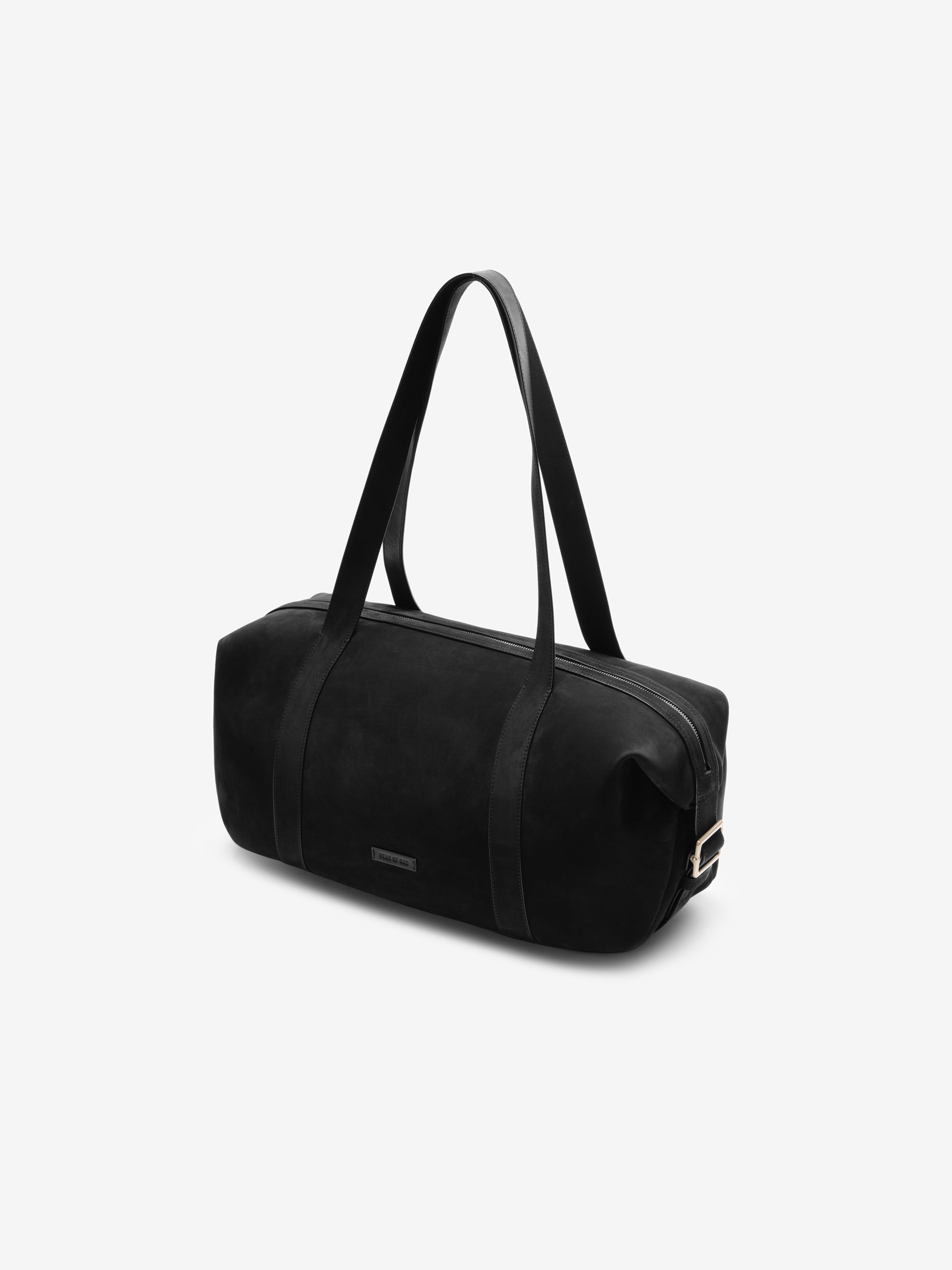 Angled view of a Small Belted Duffle in black featuring smooth leather texture, long shoulder straps, and a subtle, minimalist logo plaque for a sleek, modern look.