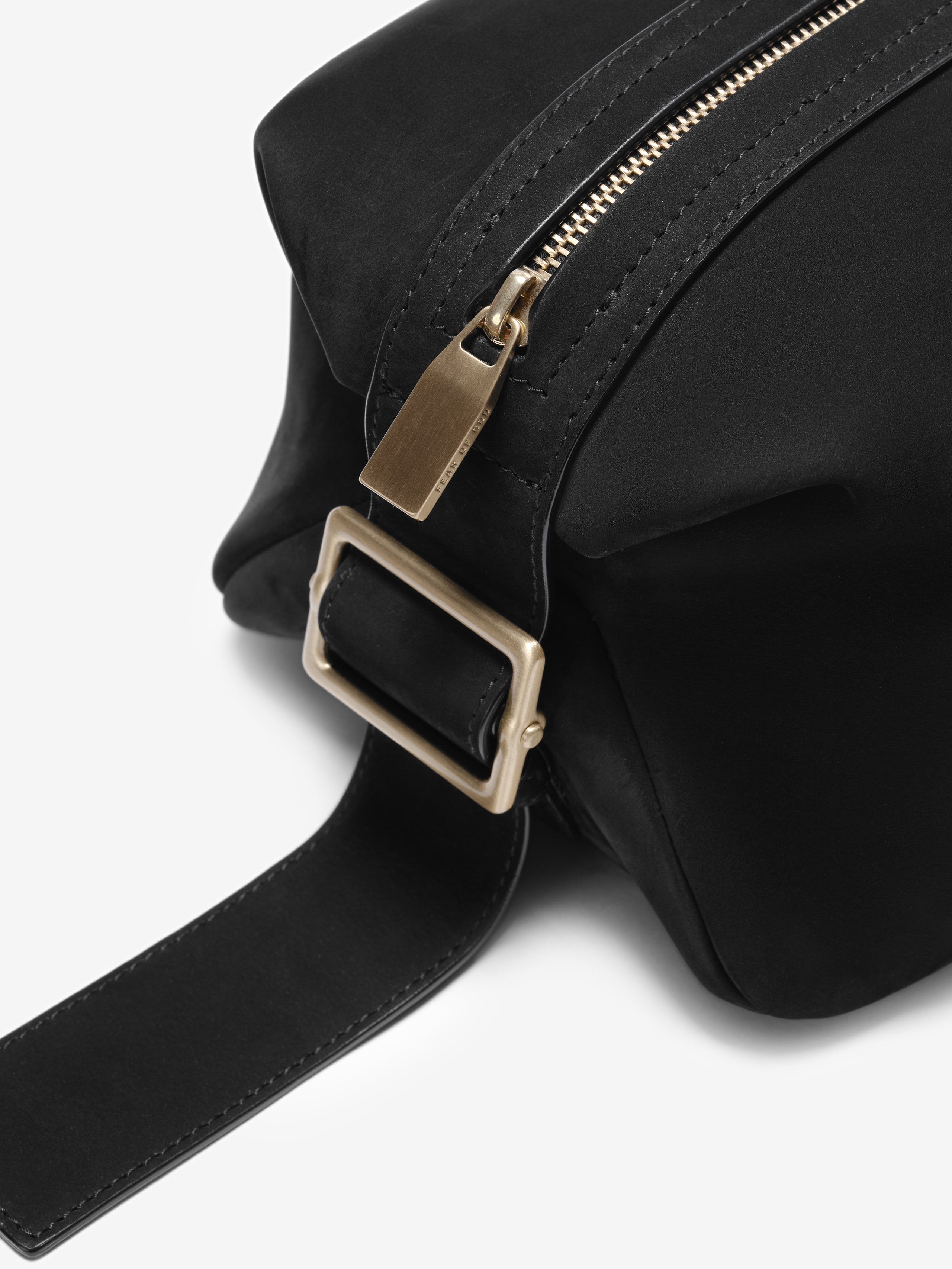 Close-up of the Nubuck Leather Belted Pouch in black, showcasing its soft textured leather, a sturdy belt strap with rectangular metal buckle, and a smooth zipper with a matte finish pull.