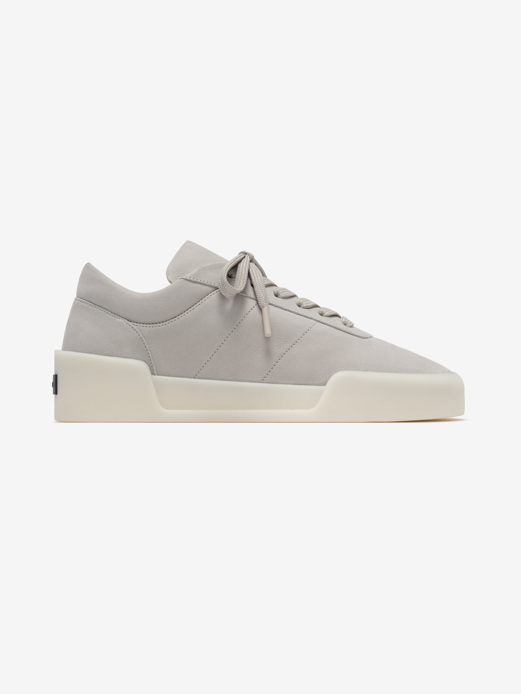 side view of light gray Italian suede low-top sneaker with sculpted cream sole and laces