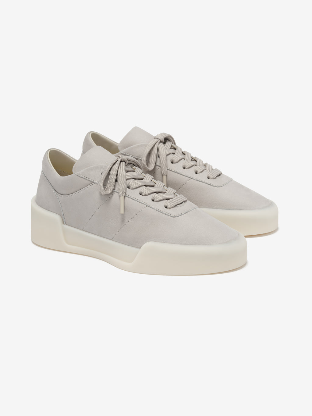 pair of light gray Italian suede low-top sneakers with sculpted cream rubber soles and laces angled right