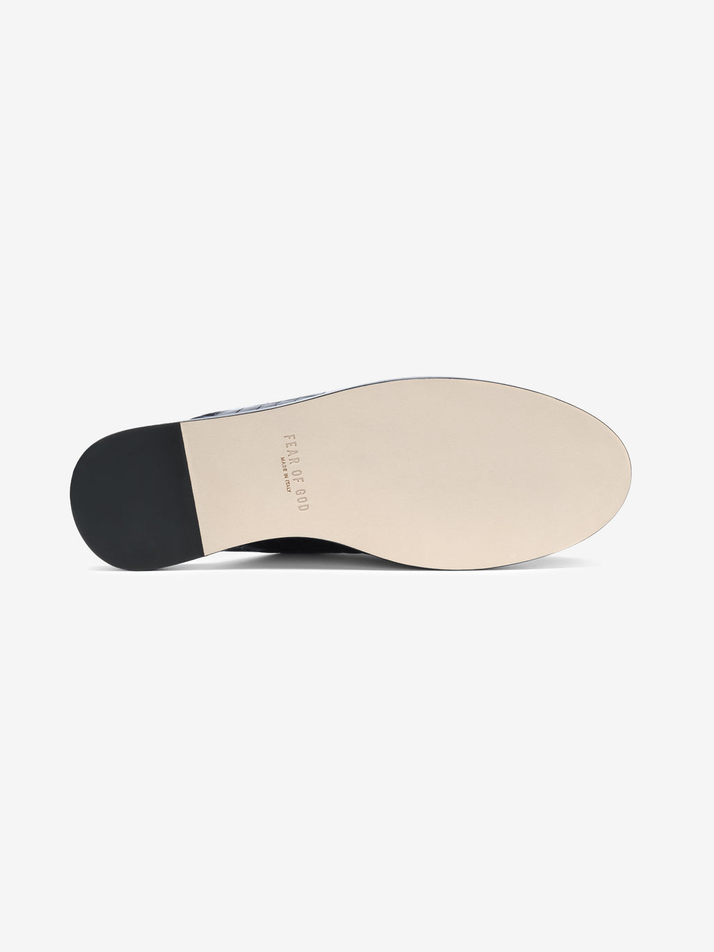 Underside view of a smooth beige shoe sole with black heel and faint embossed branding text on a white background