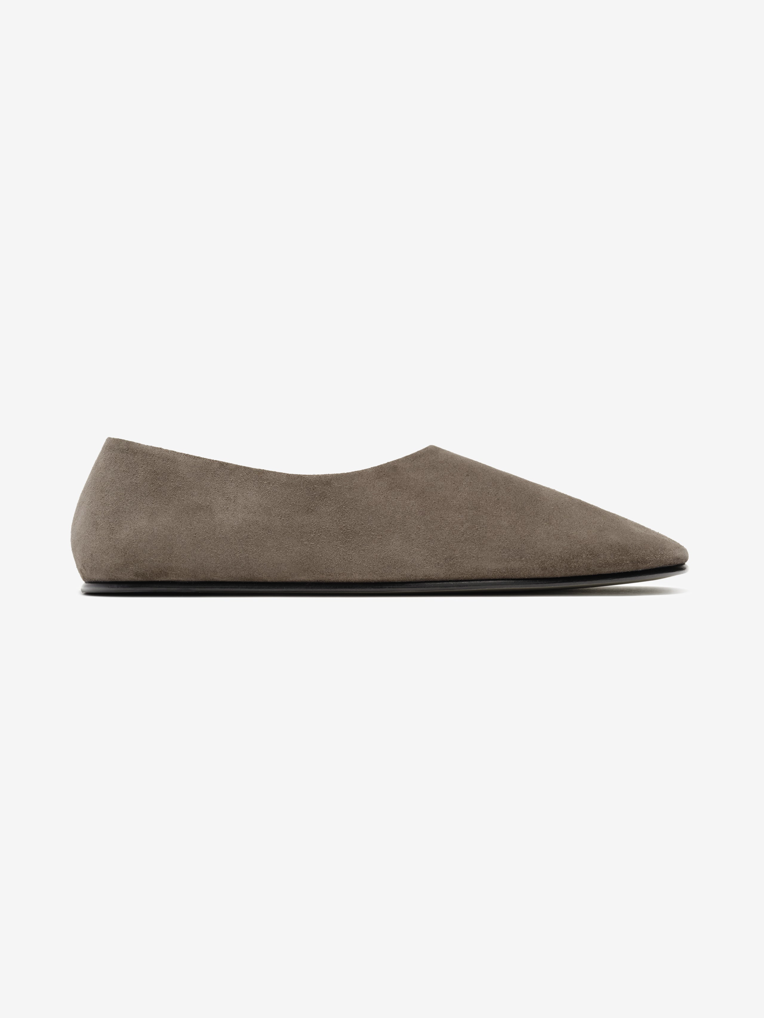 Minimalist taupe suede flat shoe with pointed toe and low profile silhouette against a white background