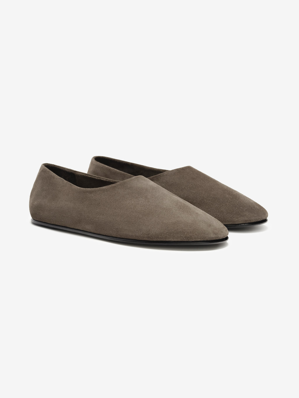 Pair of taupe soft suede ballet flats with a sleek pointed toe and low profile black sole on a white background