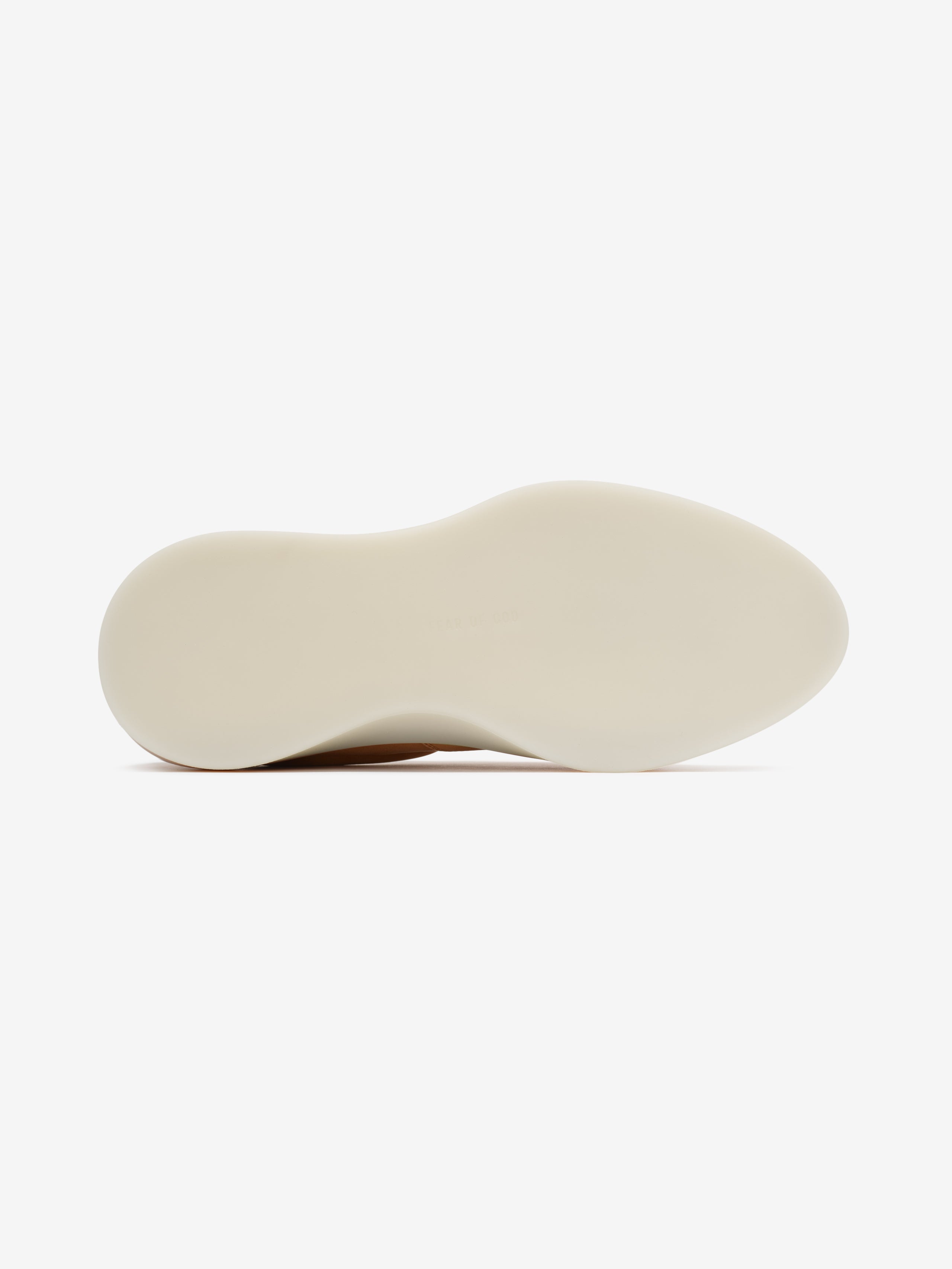 smooth cream-colored sculpted rubber outsole of 101 Italian suede deck sneaker viewed from bottom angle