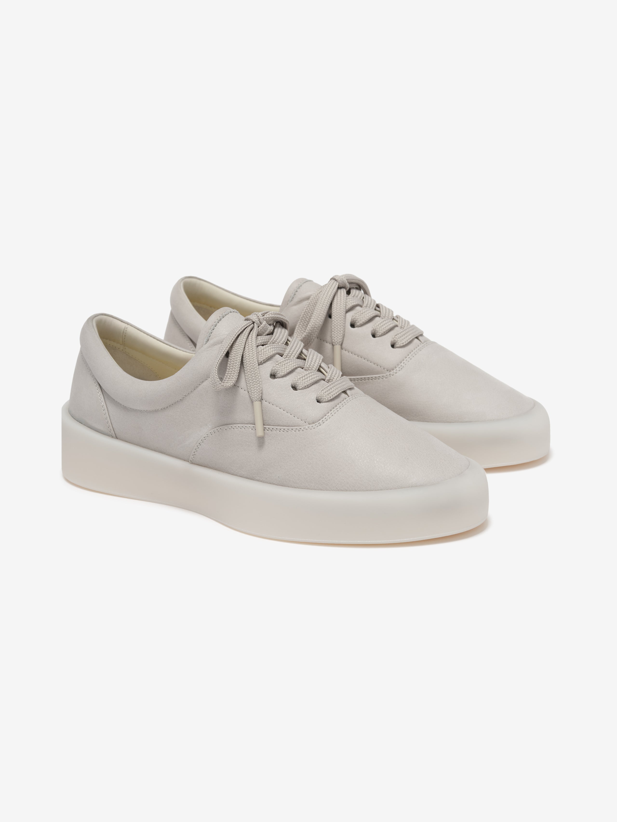 pair of off-white Italian suede low-top sneakers with sculpted rubber soles and tonal laces angled right side view
