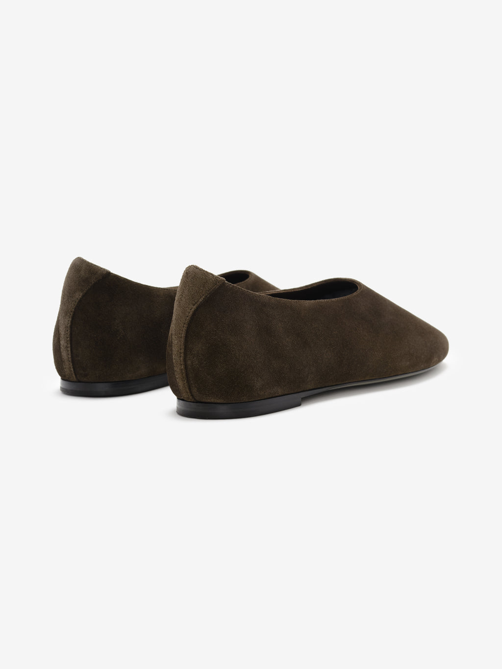 Pair of dark brown suede ballet flats with rounded toes and slim black soles on a white background