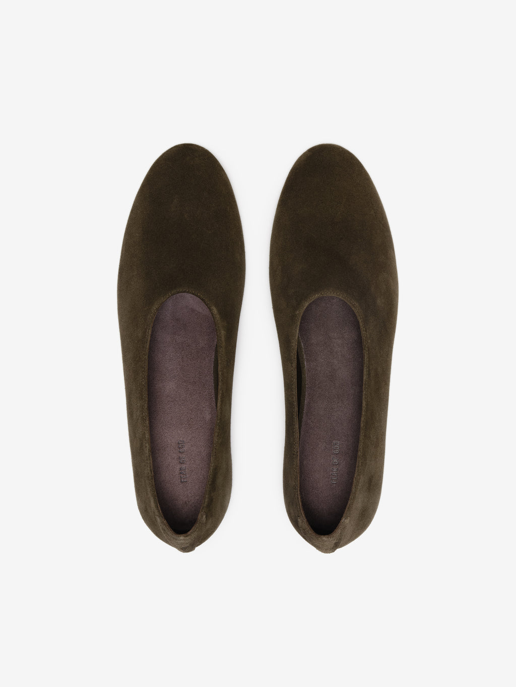 Pair of dark brown suede slip-on flats with rounded toes and smooth insoles on a white background
