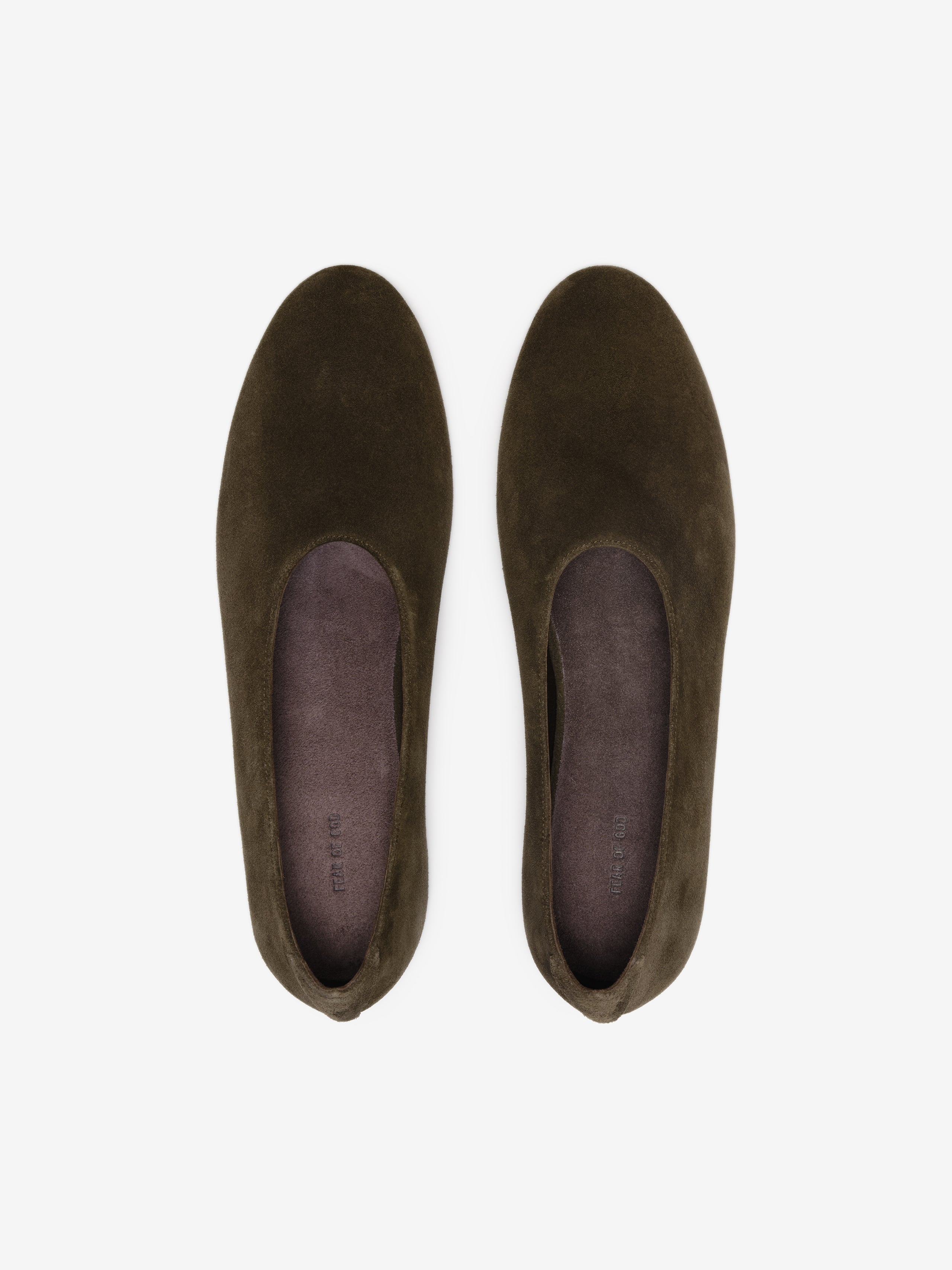 Pair of dark brown suede slip-on flats with rounded toes and smooth insoles on a white background