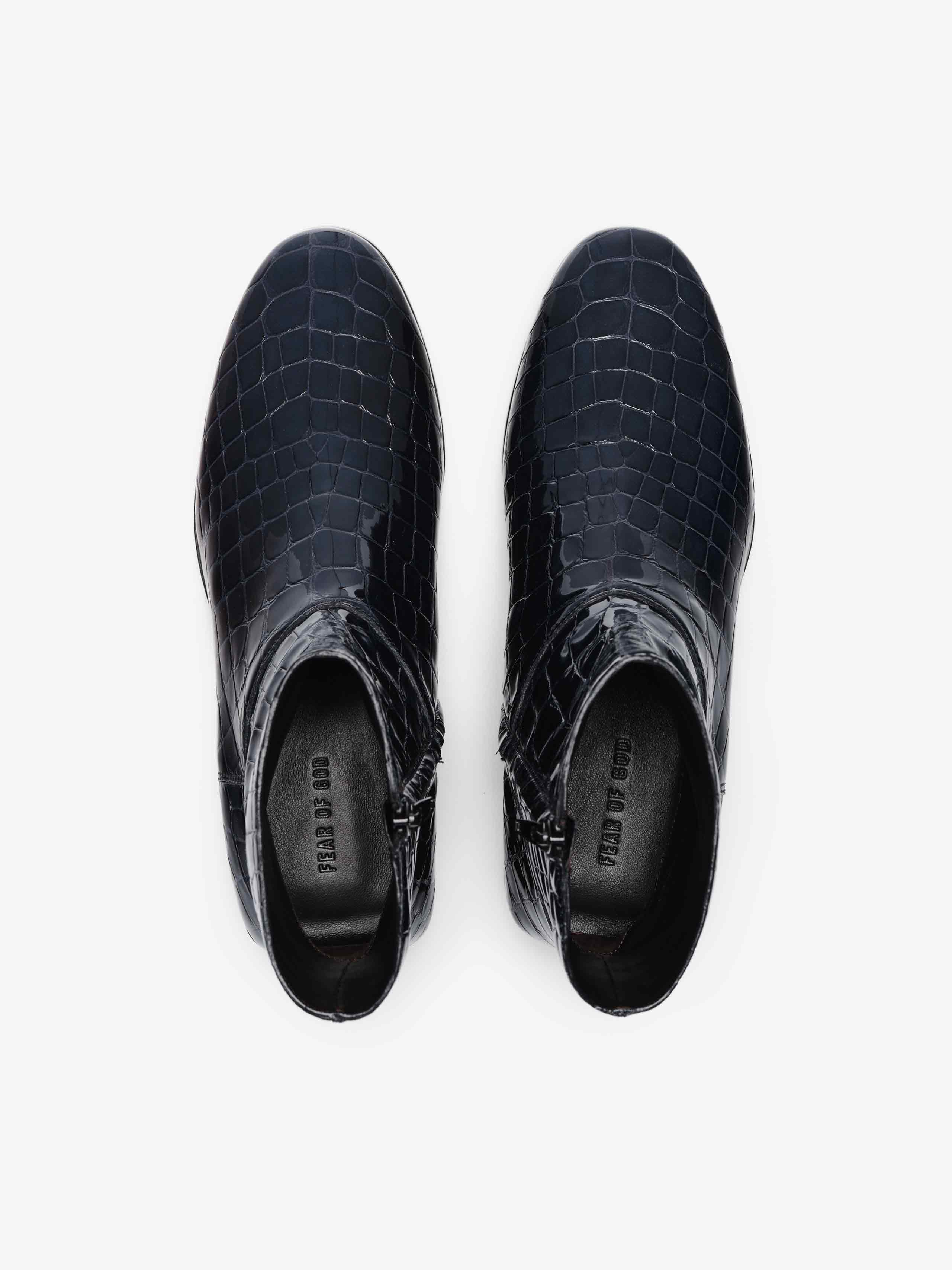 Croc Printed Ankle Boot in deep midnight blue featuring a glossy croc-embossed finish, rounded toe, side zipper closure, and low stacked heel for refined and stylish footwear.