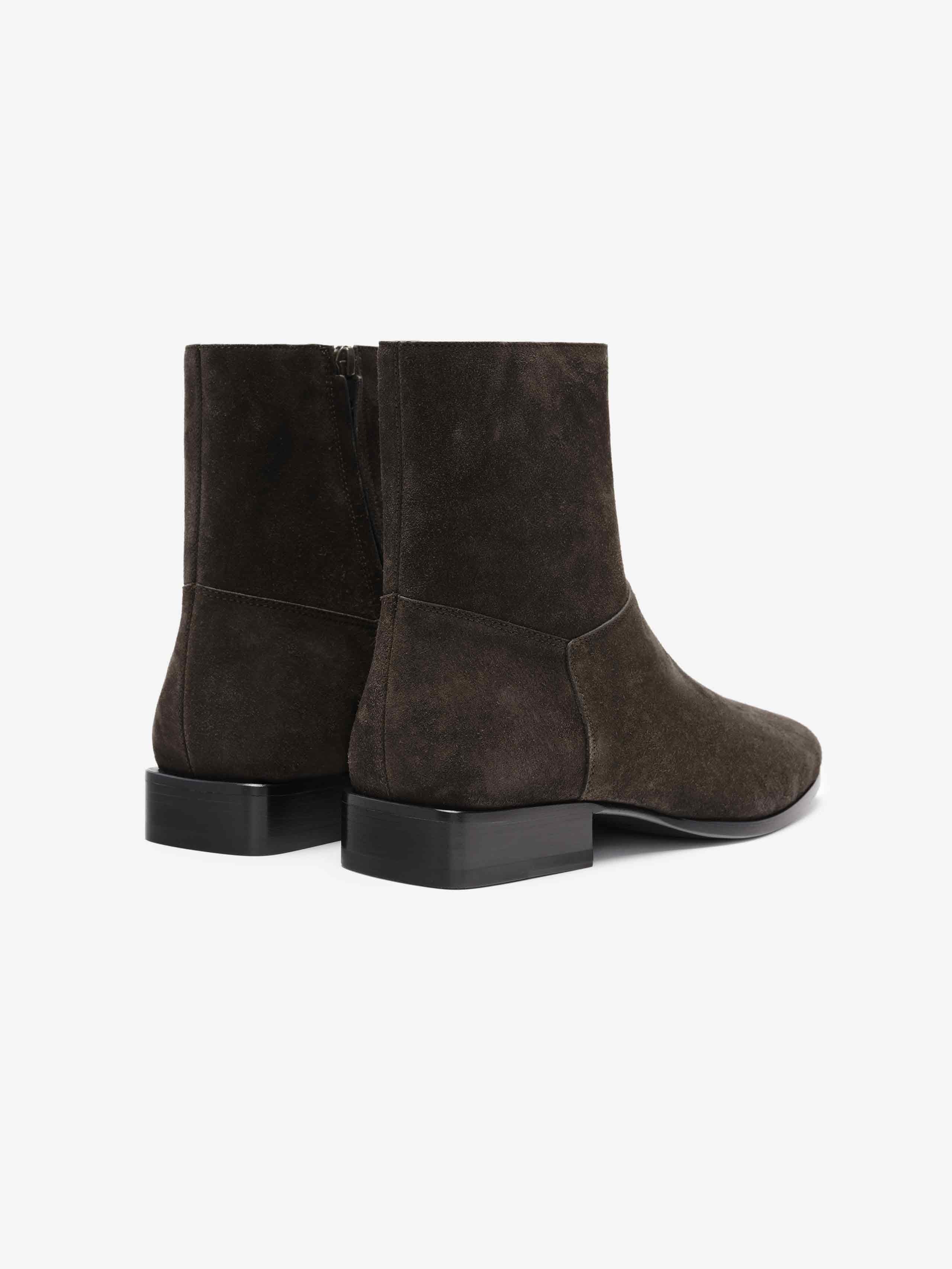 Suede Ankle Boot featuring a dark brown suede upper with a minimalist design, side zipper closure, rounded toes, and a low stacked heel for elegant and versatile footwear.