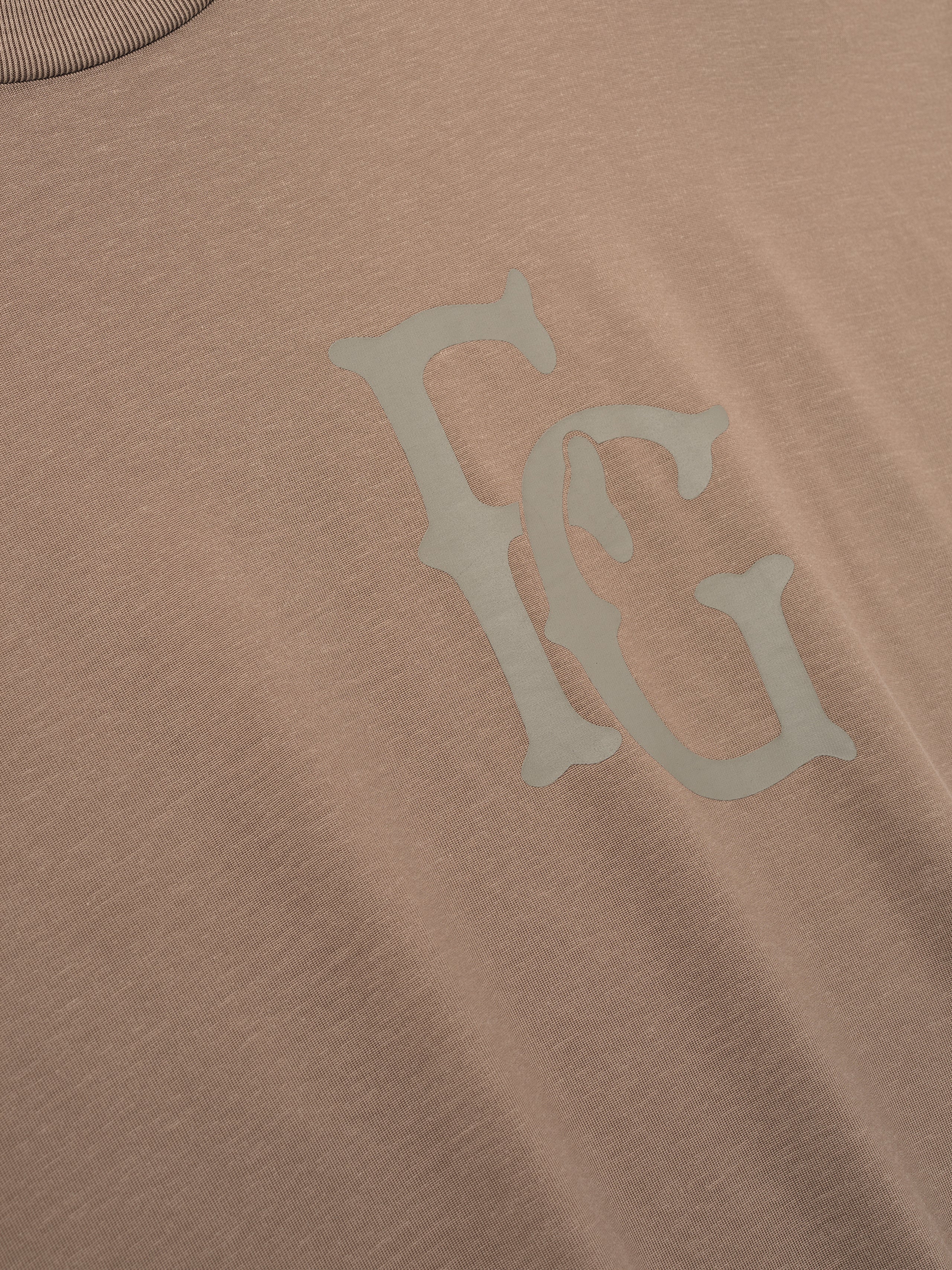 taupe cotton-rayon tee with subtle hand-printed FG logo on chest and vintage garment wash finish