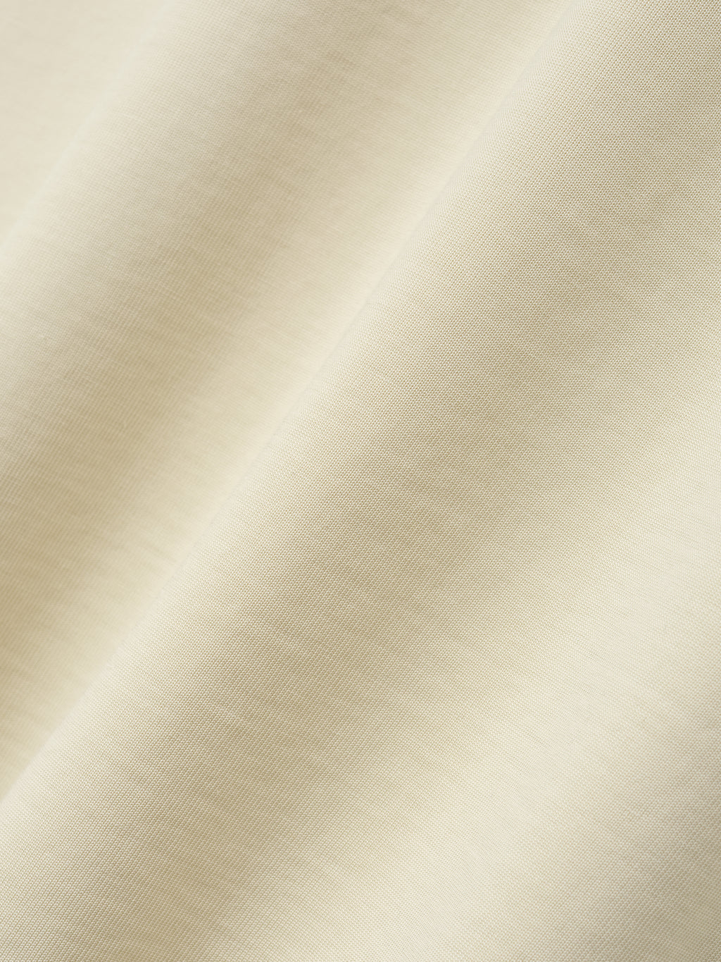 close-up of soft off-white cotton-rayon fabric showing smooth texture and subtle vintage wash effect