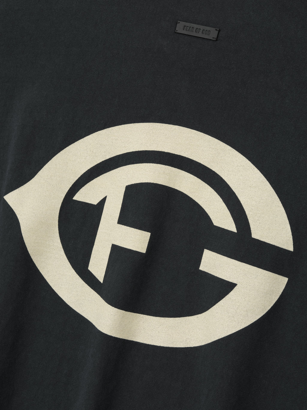 black heavyweight cotton tee with large vintage-style FG logo hand-printed on front chest in faded cream color