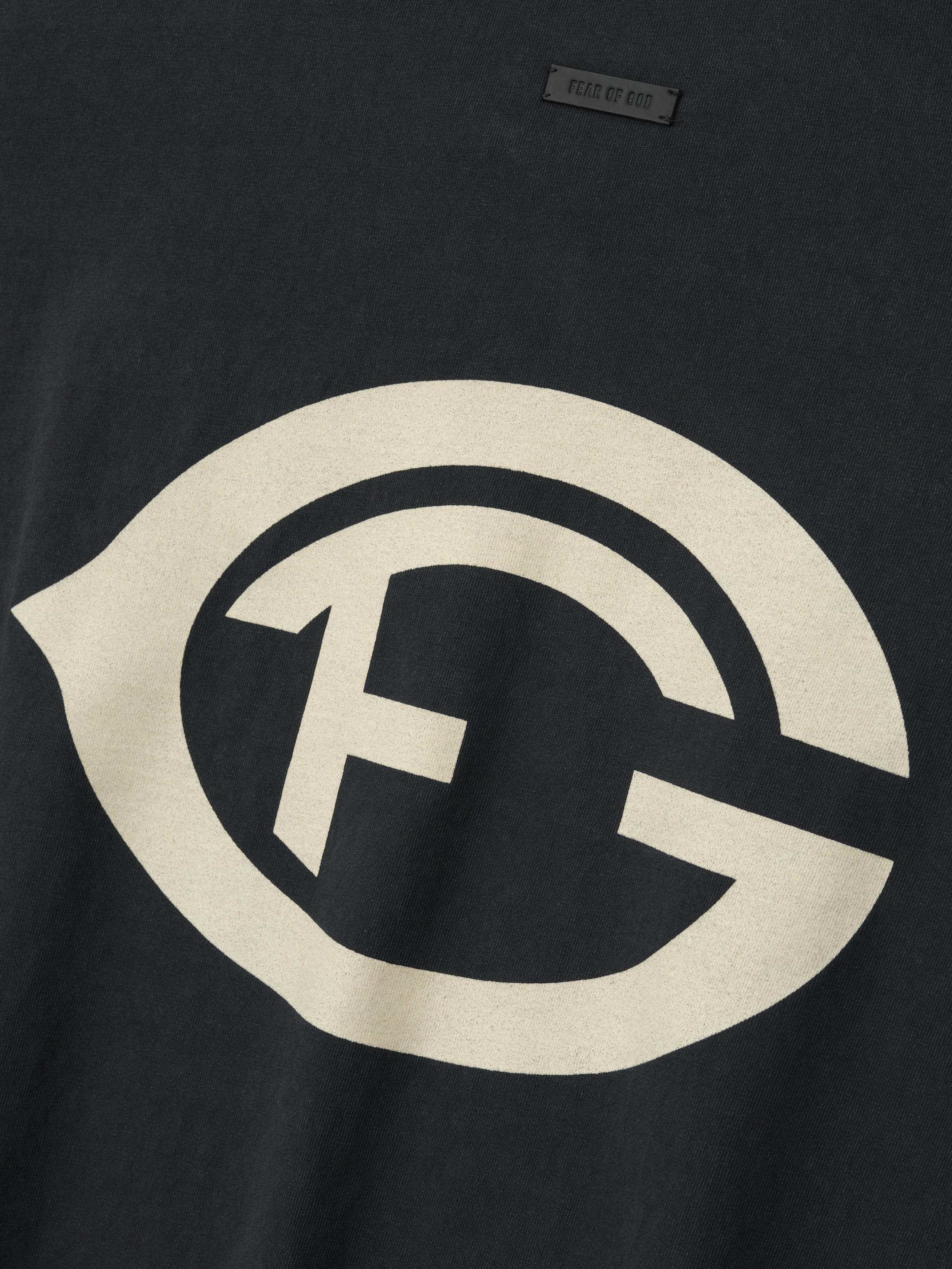 black heavyweight cotton tee with large vintage-style FG logo hand-printed on front chest in faded cream color