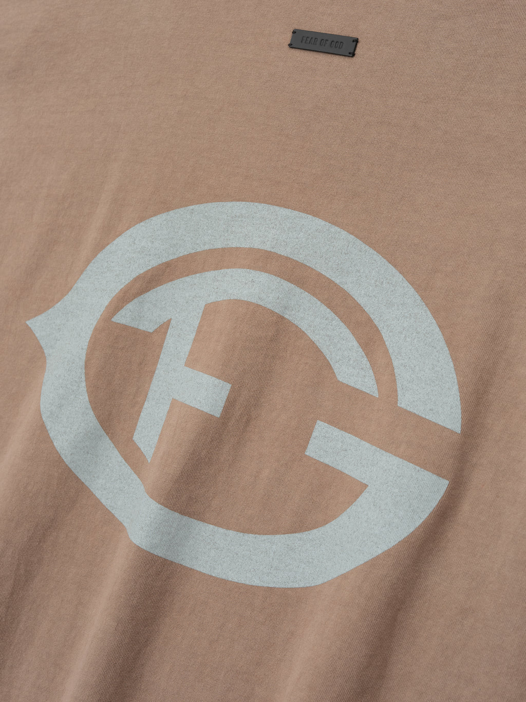 taupe heavyweight cotton tee with large distressed light gray FG insignia printed on front chest
