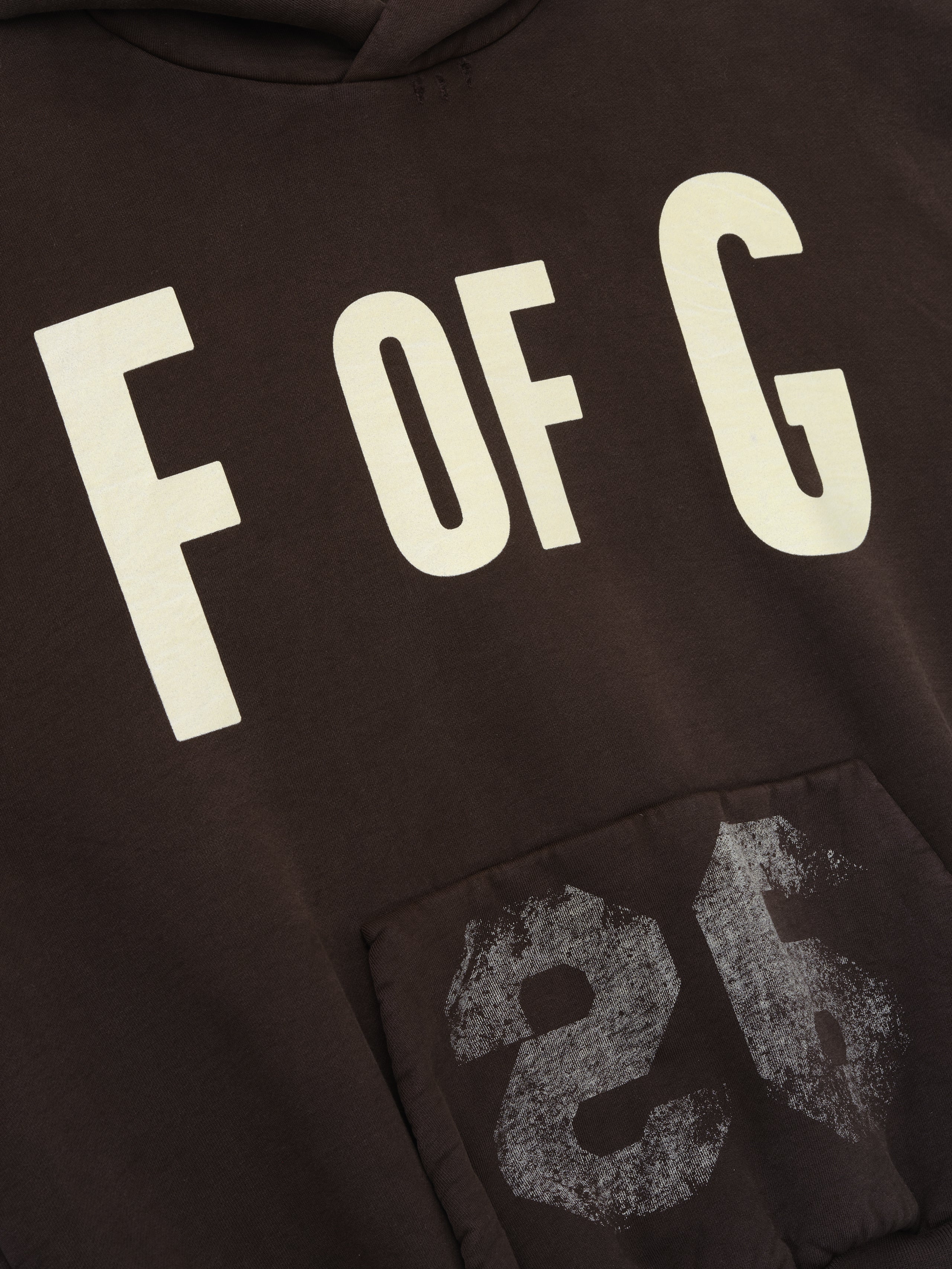 dark brown heavyweight cotton fleece hoodie with large "F OF G" print and distressed "26" graphic on front pocket