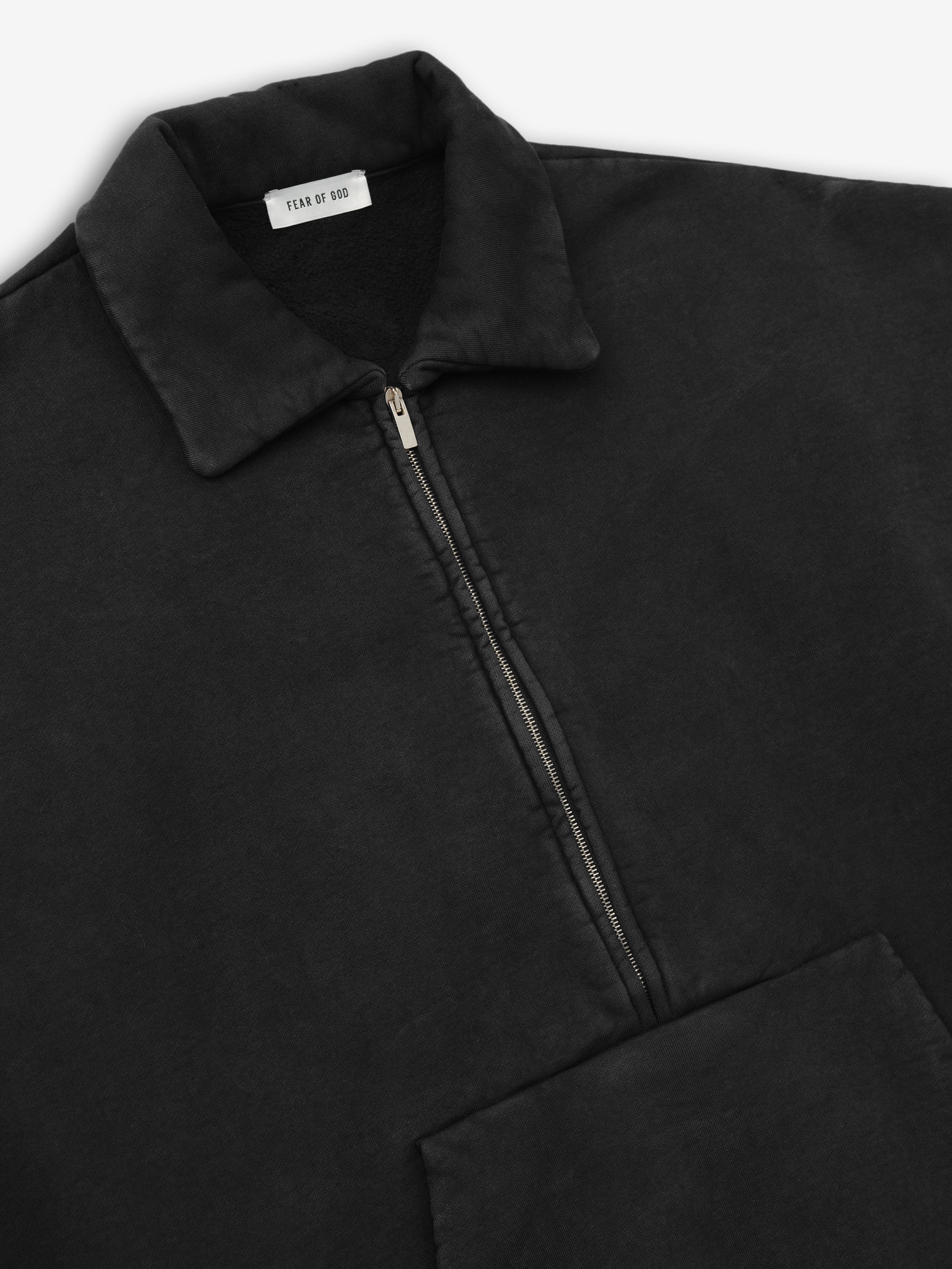 close-up of vintage faded black cotton fleece half zip polo sweatshirt with collar and zip detailing