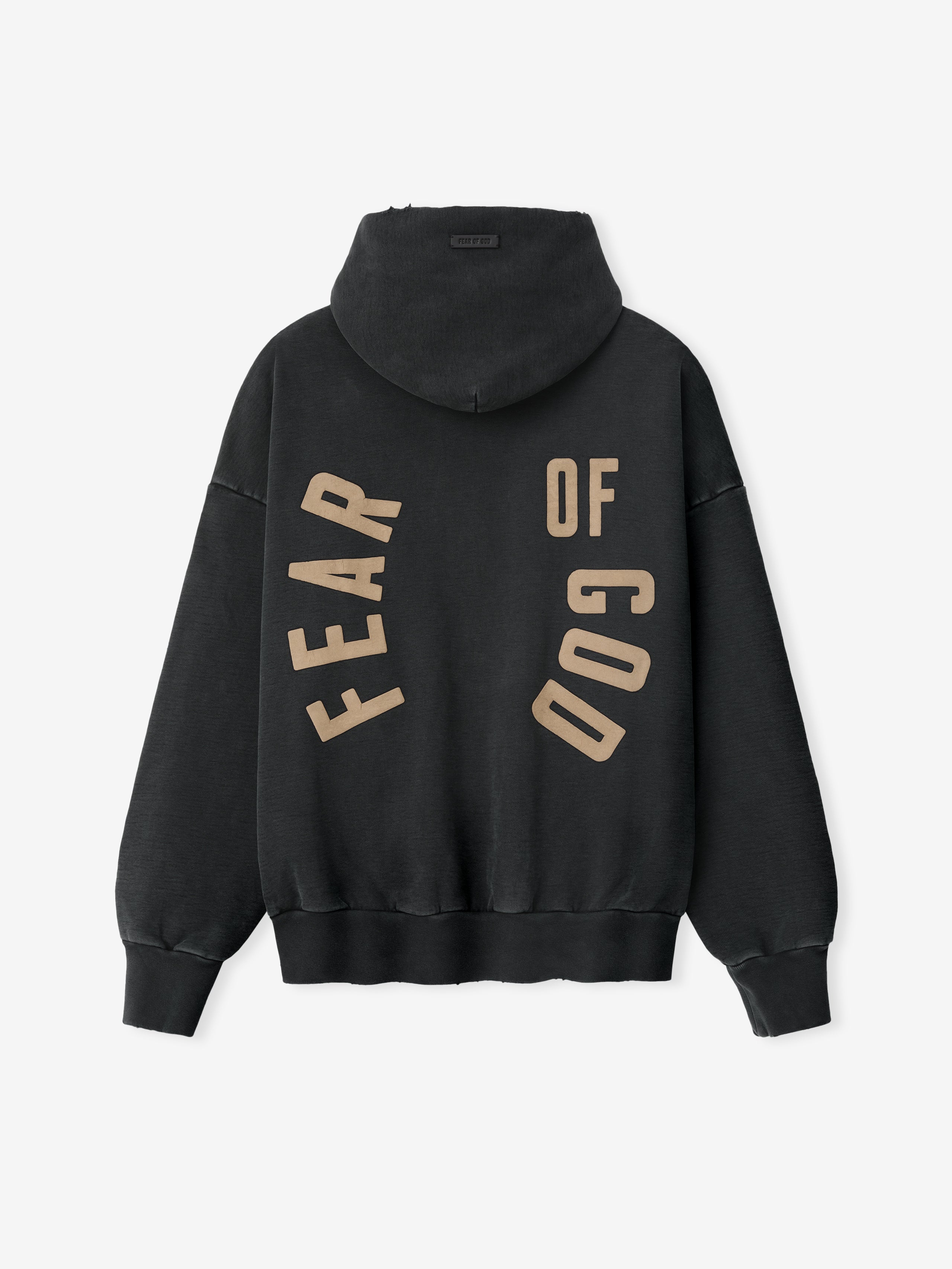 Black hoodie back with large tan block letters "FEAR OF GOD" arranged in a curved design across fabric