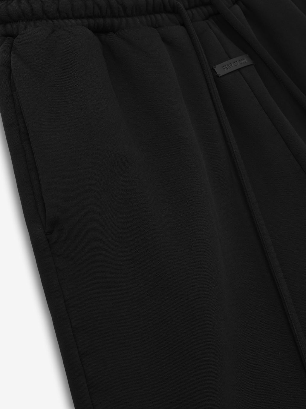 close-up of black cotton fleece vacation sweatshort with elastic waistband, drawstring, and side seam pocket detail