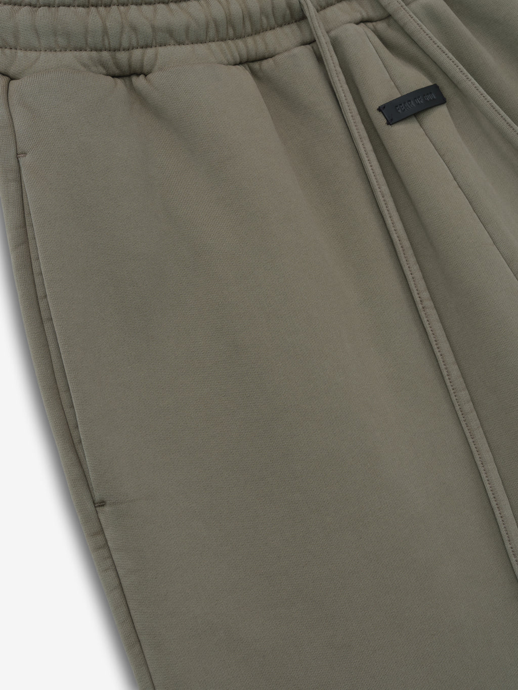 close-up of olive green cotton fleece wide leg sweatpants with elastic waistband, drawstring, and side pocket detail
