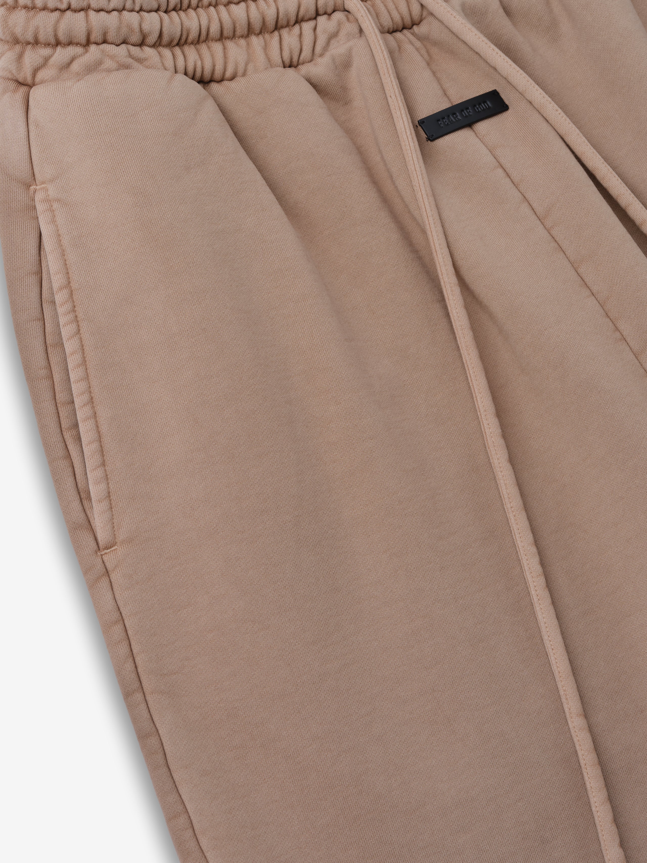 close-up of taupe heavyweight cotton fleece sweatpants with elastic drawstring waistband and side pockets