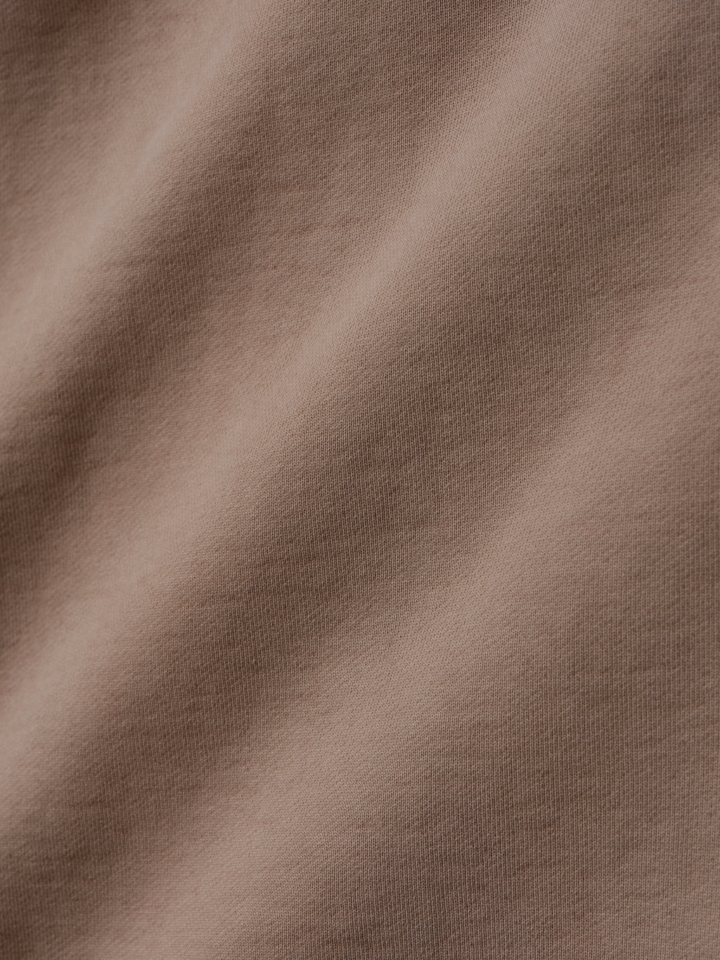 close-up of taupe heavyweight cotton fleece fabric with soft texture and subtle garment-washed vintage finish