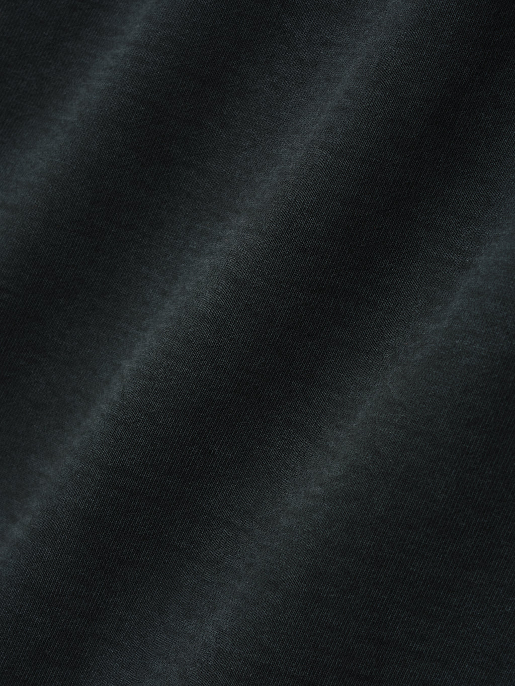 close-up of black garment dyed brushed heavy cotton fleece fabric with soft textured finish