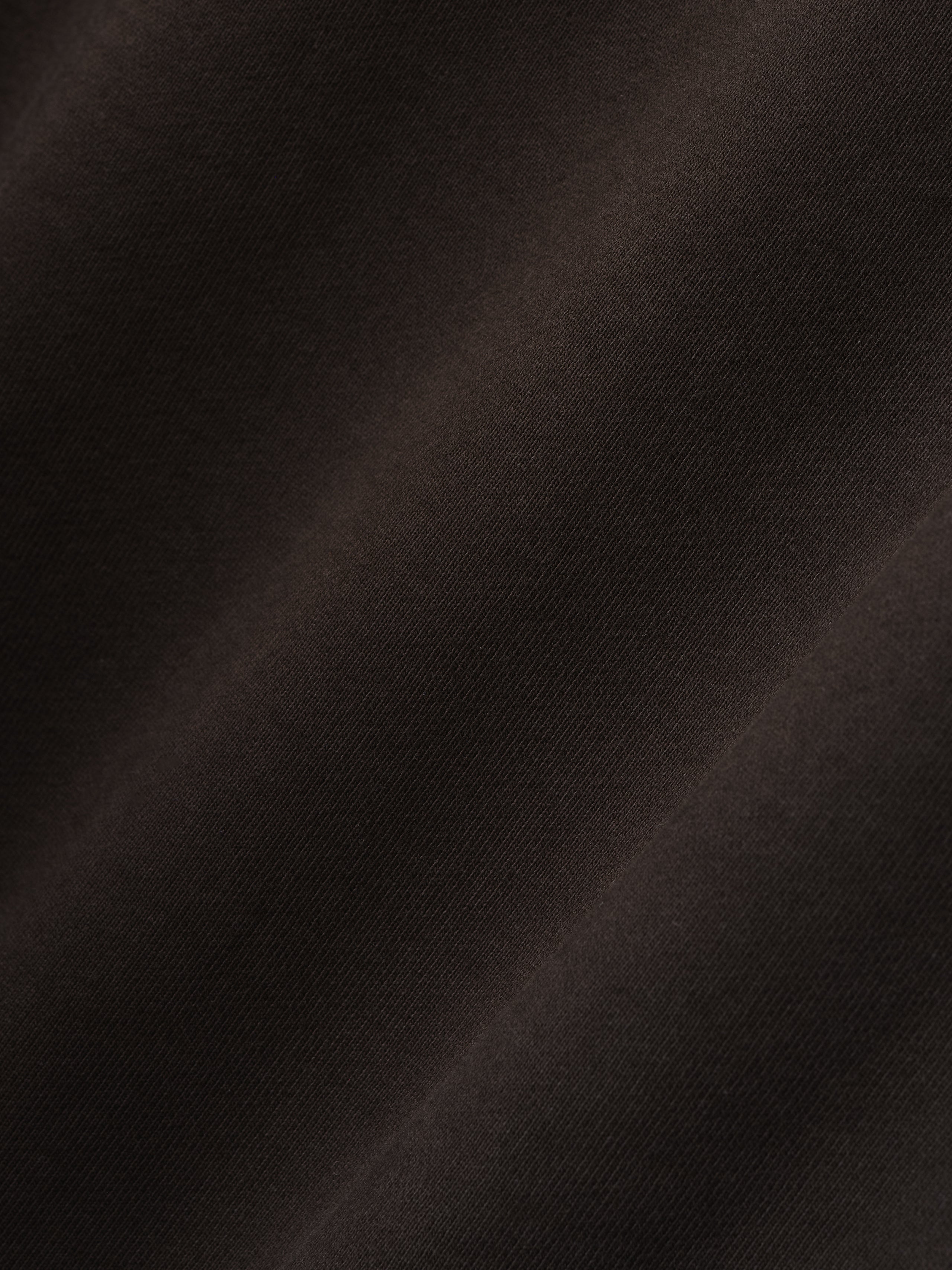close-up of dark brown heavyweight cotton fleece fabric with soft texture and subtle sunfade garment wash finish