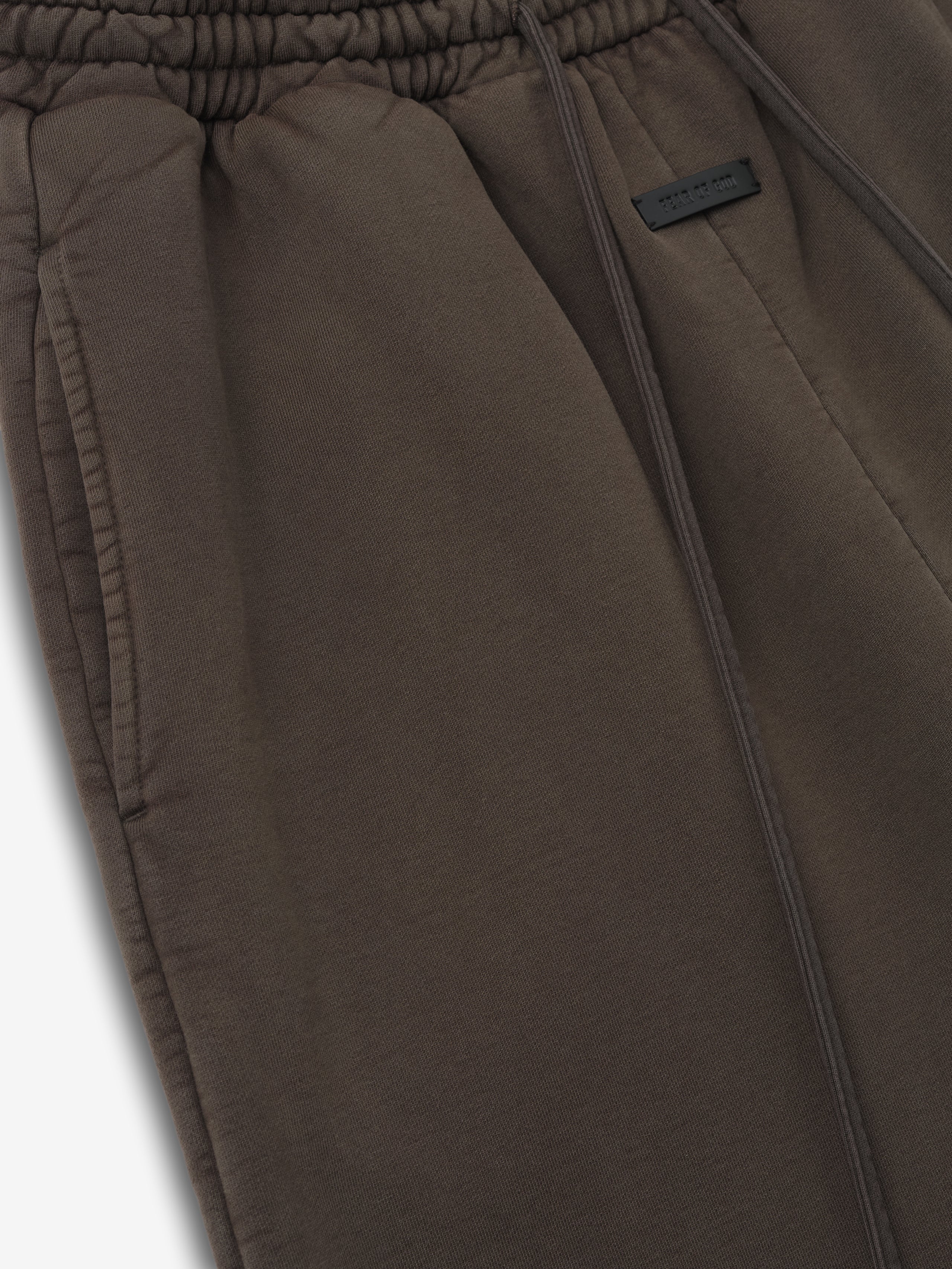 close-up of sunfaded dark taupe cotton fleece sweatpants with elastic waistband and front side pocket detailing