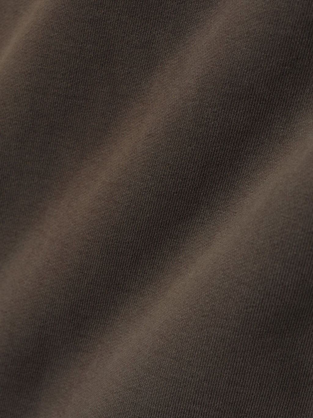close-up of heavyweight cotton fleece fabric in sunfaded dark brown showing soft texture and vintage wash effect