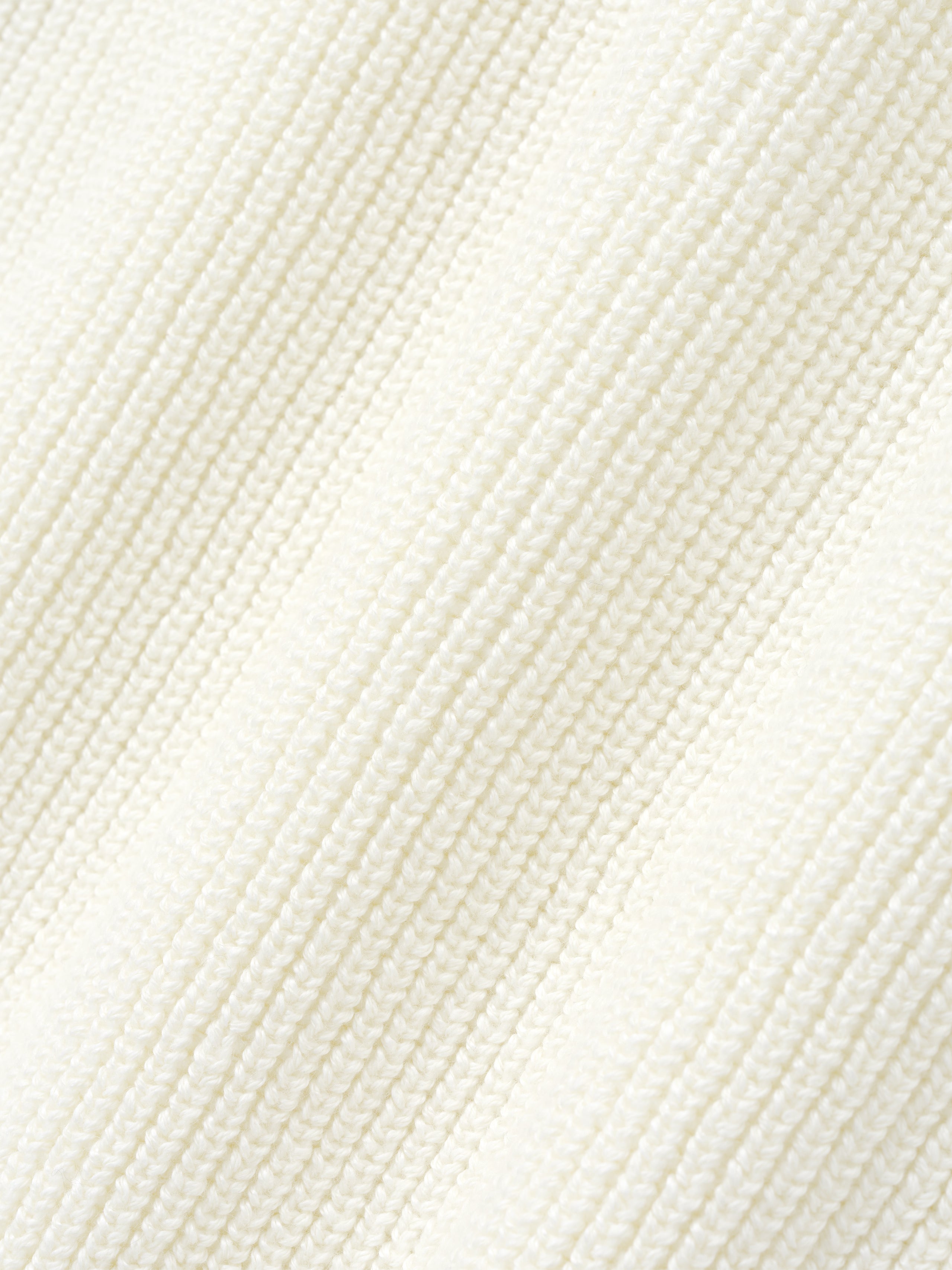 close-up detail of textured off-white double-knit linen-wool-cotton fabric with fine ribbed pattern