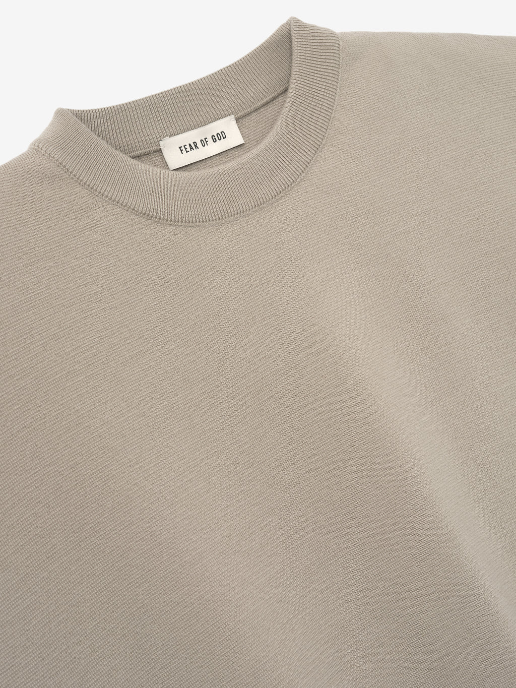 close-up of light taupe Merino Milano stitch knit tee with ribbed crew neck and smooth fine knit texture