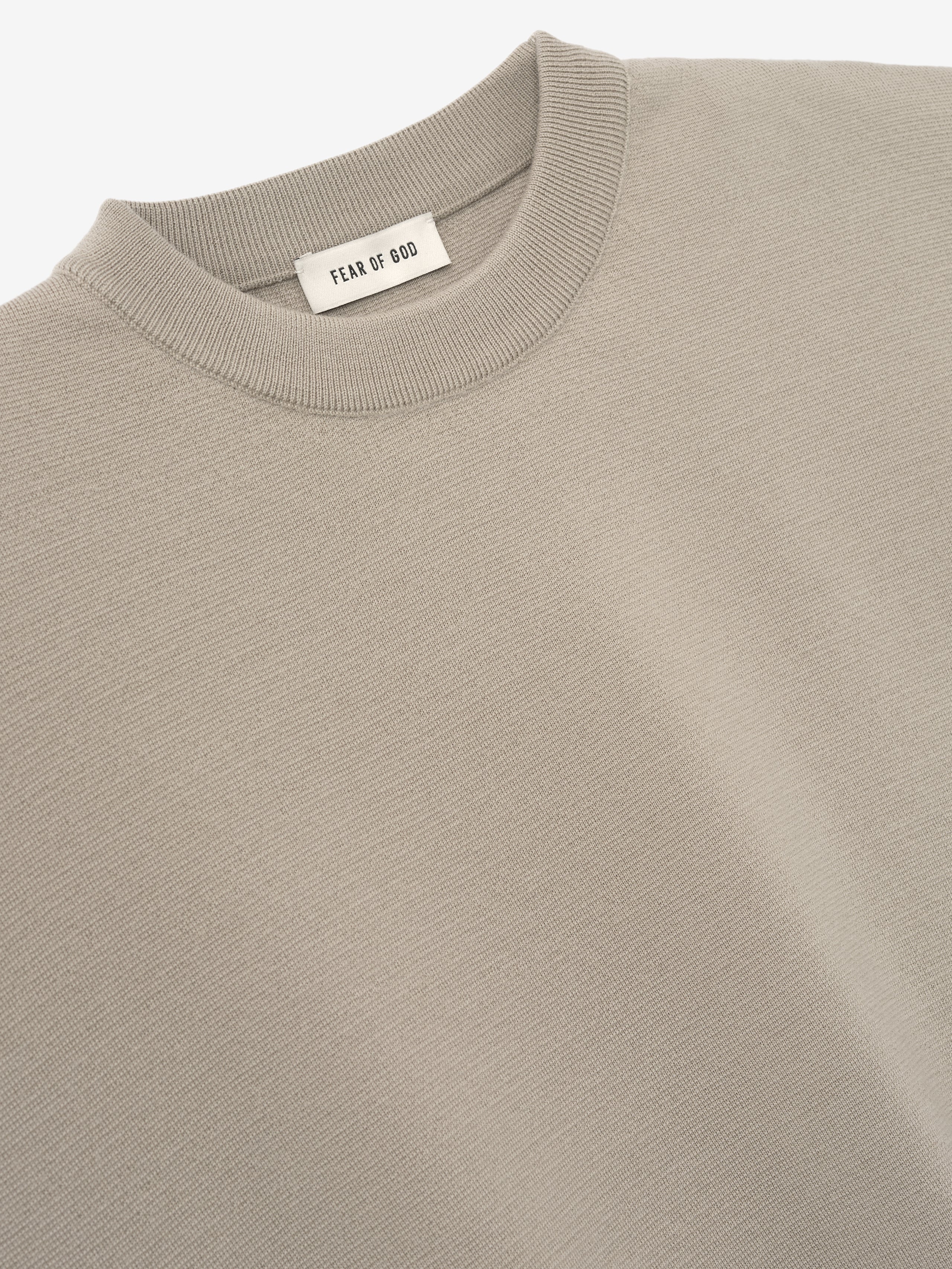 close-up of light taupe Merino Milano stitch knit tee with ribbed crew neck and smooth fine knit texture