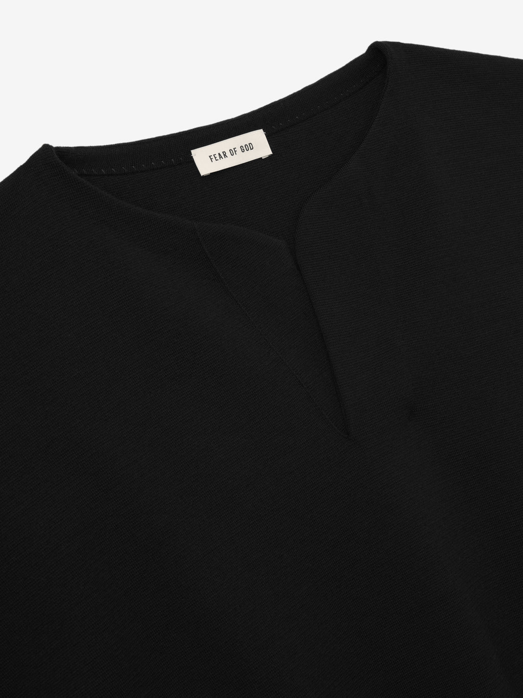 close-up of black Merino Milano knit Henley sweater neckline with subtle V-shaped opening and Fear of God label