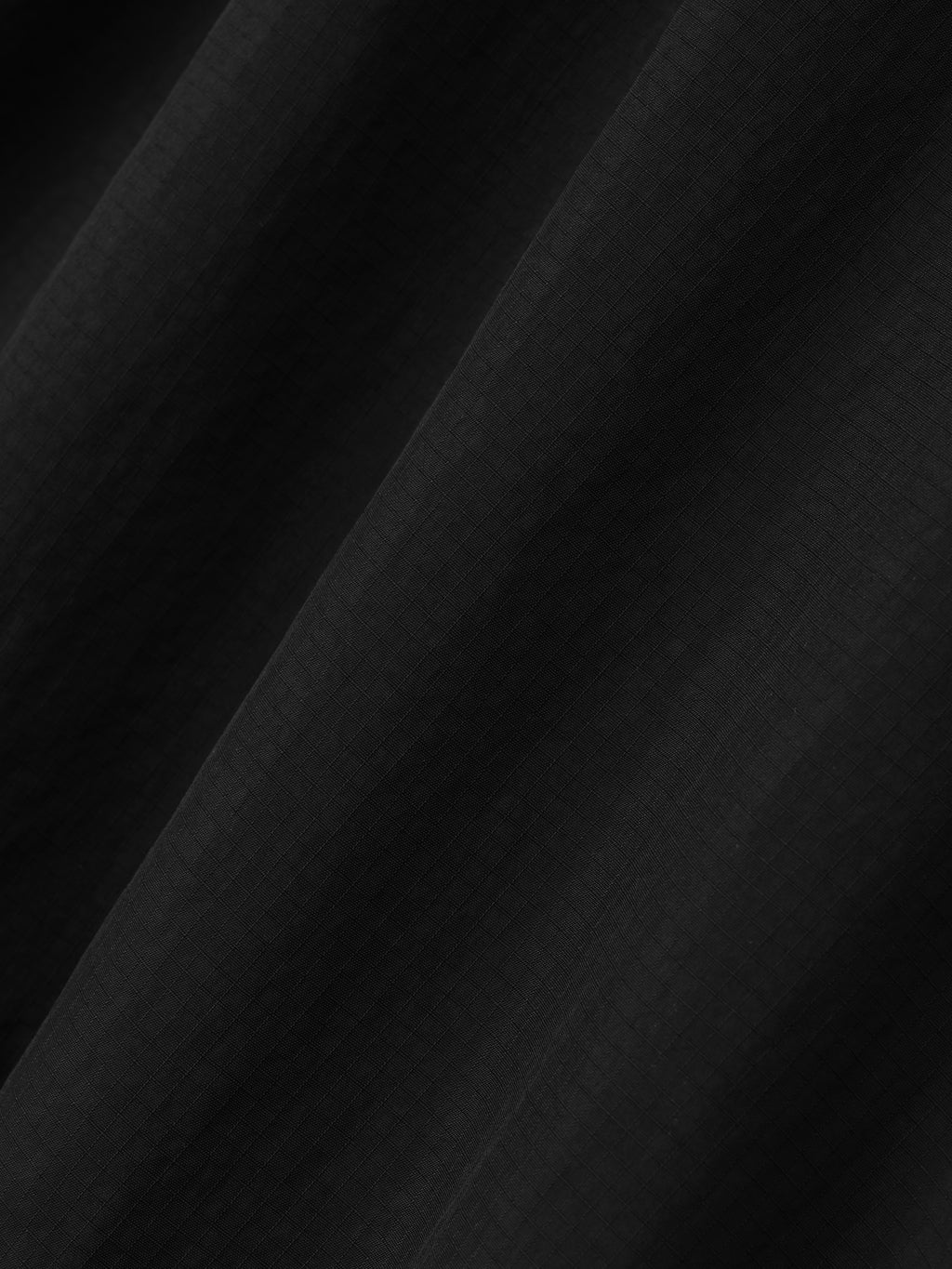 black recycled nylon ripstop fabric with subtle grid texture and soft matte finish in lightweight sport short material